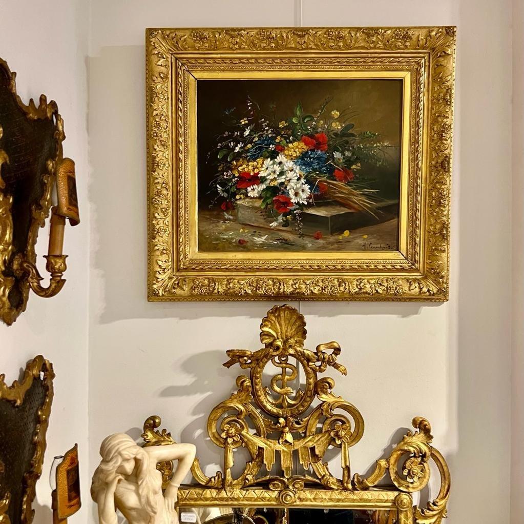 Nous vous présentons cette merveilleuse huile sur toile de nature morte représentant un bouquet de fleurs champêtres par Eugène Henri Cauchois (1850-1911). Il est composé de fleurs, notamment de coquelicots, de marguerites, de bleuets, etc. et est