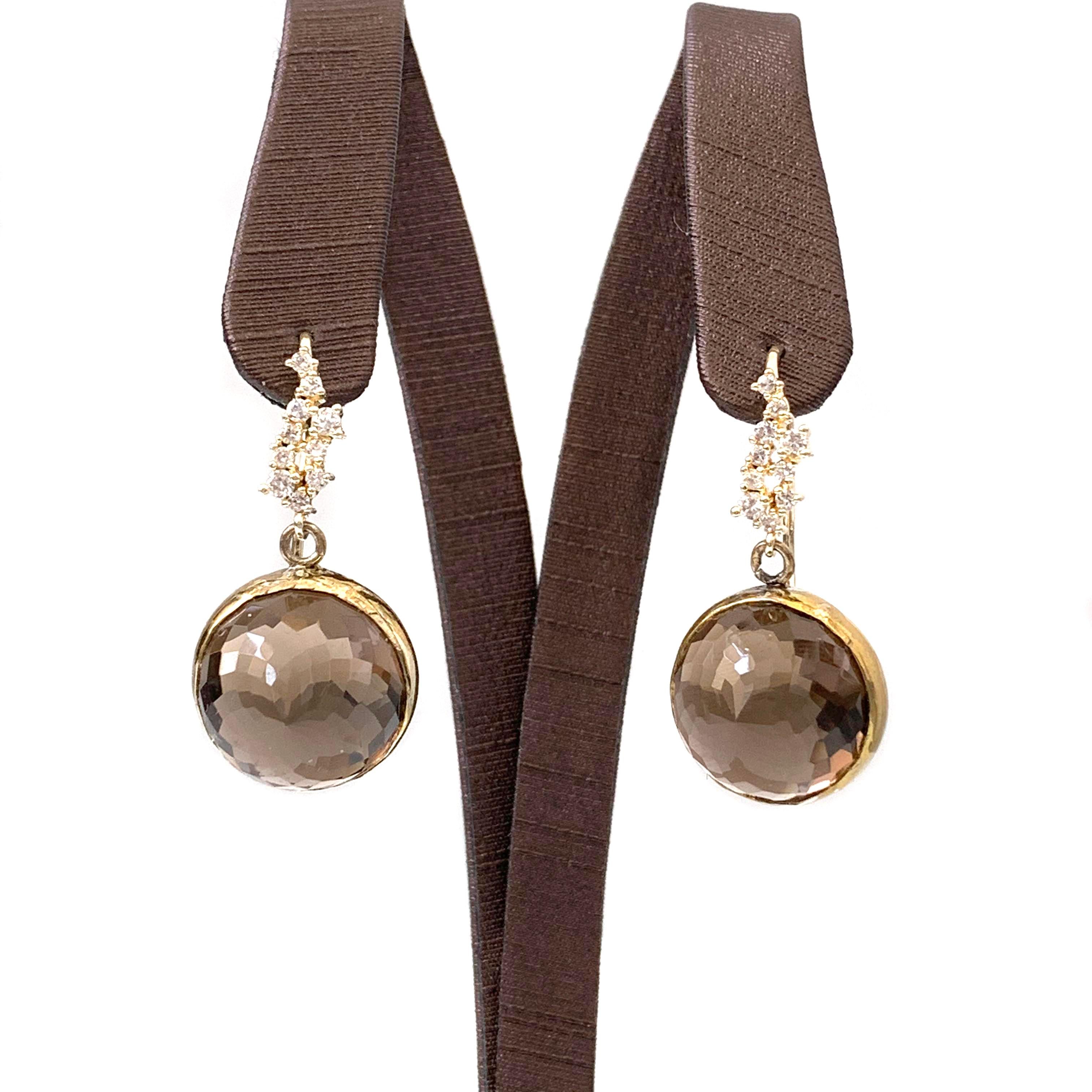 Flower pattern facet smoky quartz (15mm) vermeil hook earrings.

The earrings feature 2 beautiful 15mm round smoky quartz faceted in flower pattern, and 18k gold vermeil over sterling silver hook adorned with round faux diamond cubic zirconia.