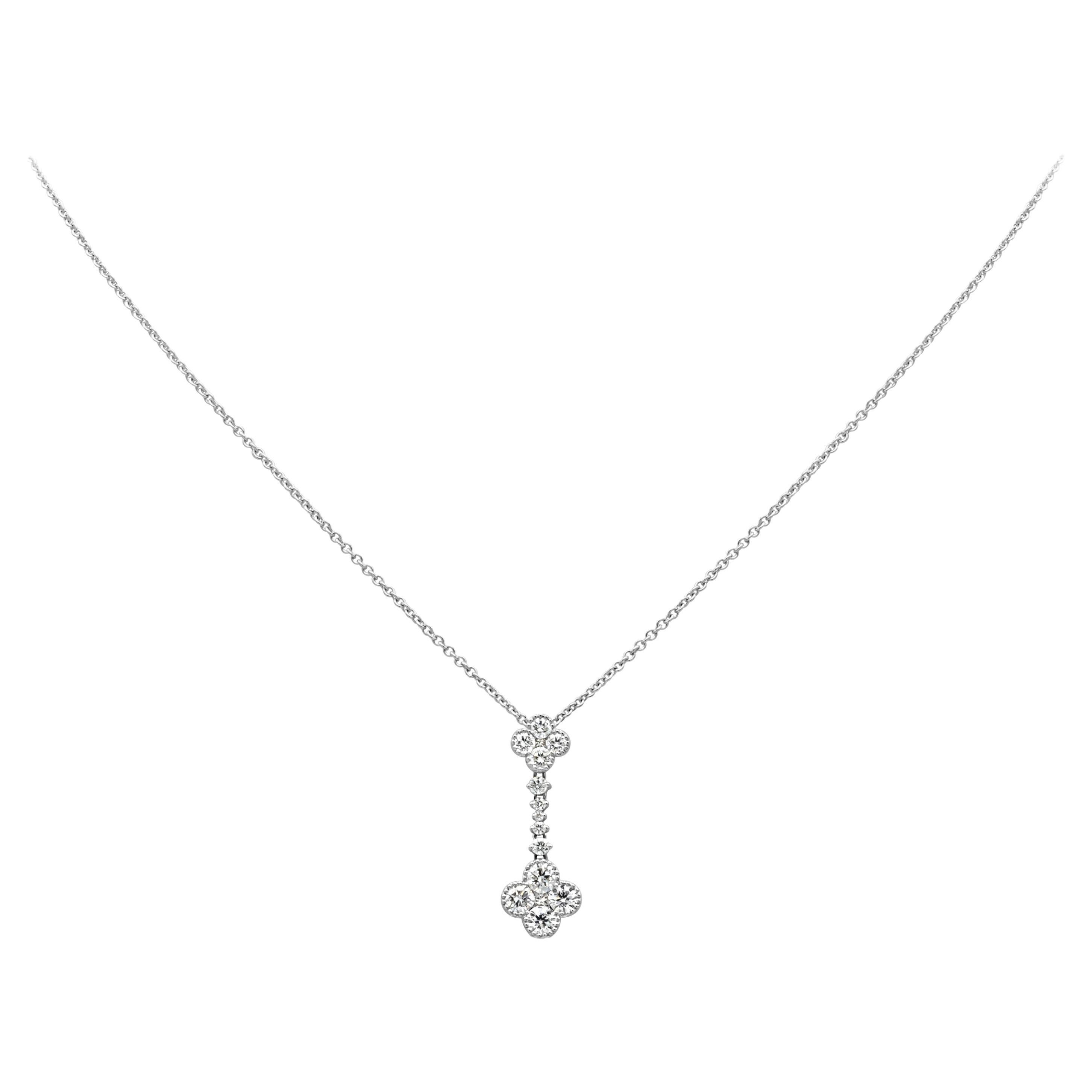 This stylish and unique drop pendant necklace showcases 15 round diamonds set in a beautiful drop floral-motif design weighing 0.98 carats total, G color and VS-SI1 in clarity. Suspended on an adjustable 14k white gold chain and finely made in 18k