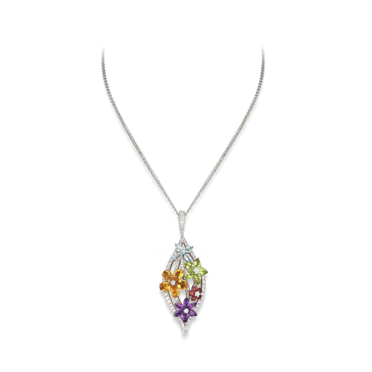 Flowers pendant in 18kt white gold set with peridots topaz and garnets 5.15 cts and 64 diamonds 1.49 cts    