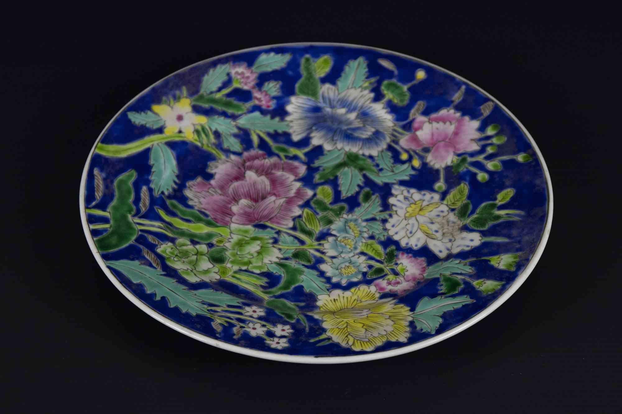 Flower plate is an original decorative object realized in the mid-20th century.

A very beautiful ceramic elegant table plate hand decorated with a flowers decorations on a blue background.

Marked under the base.

Good conditions except for