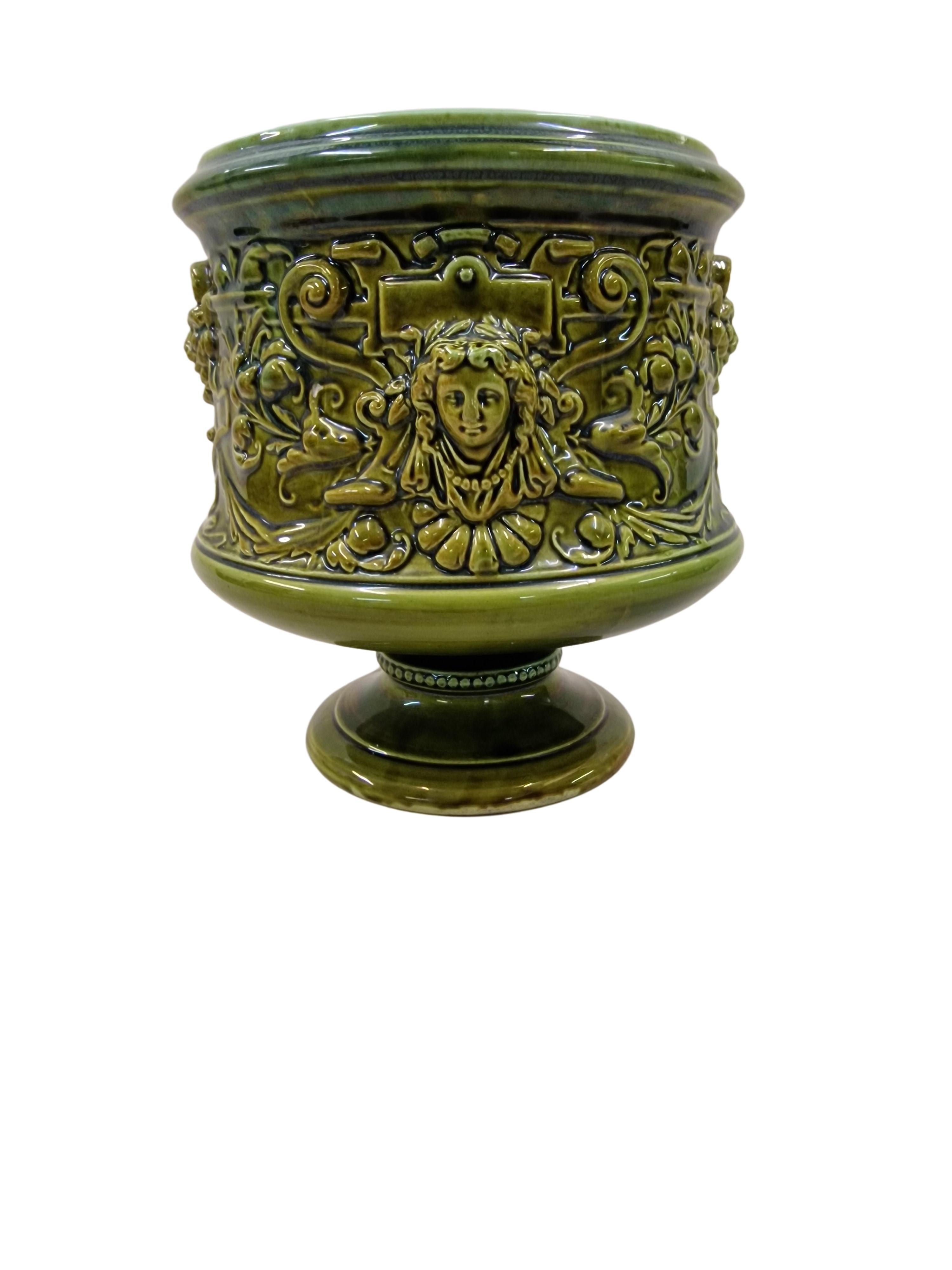Richly decorated flower pot, from the well-known manufactory Schütz Cilli, which was around 1900 active in today's region of Slovenia. 
This wonderful handmade ceramic work is of a special color - moss green. The glaze is beautifully smooth and