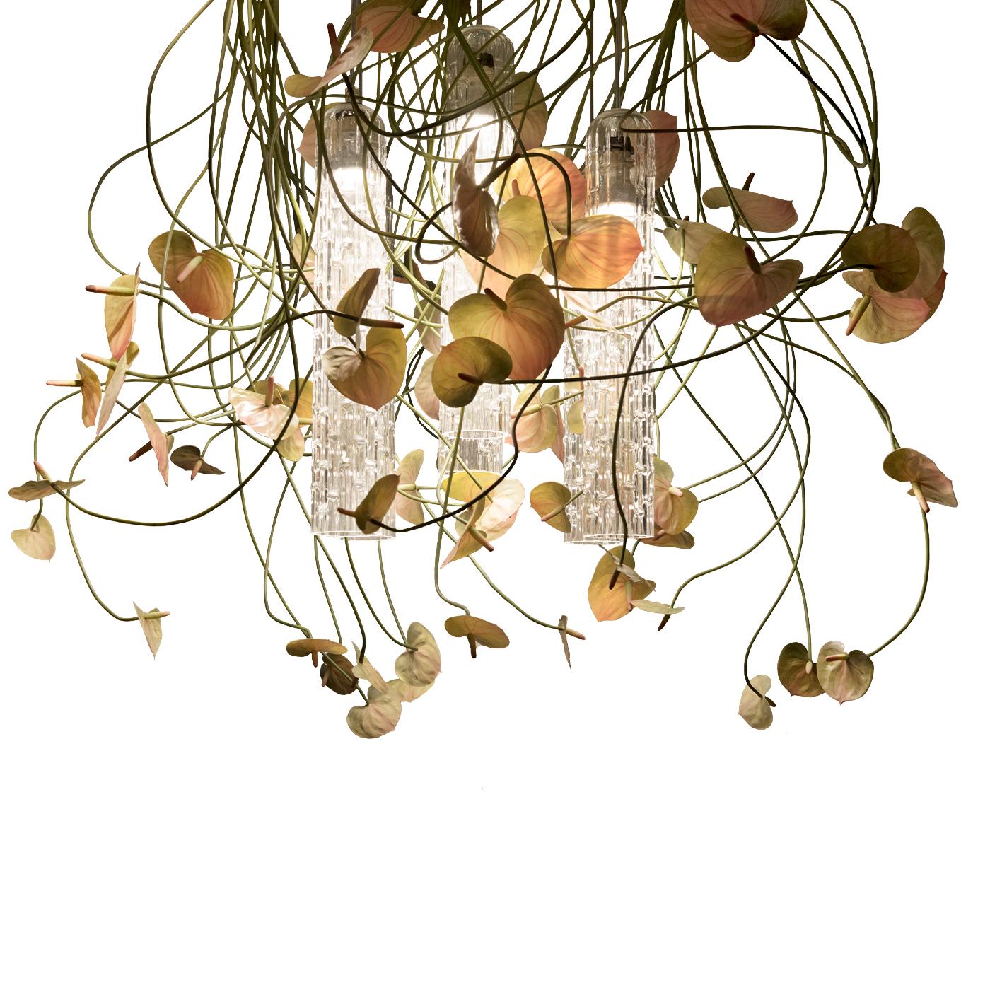 A superb, sophisticated addition to a refined contemporary interior, this ceiling lamp exudes elegance and a natural romantic charm. Mounted on a metal ceiling plate, it features a cascade of synthetic anthurium flowers and Murano glass shades