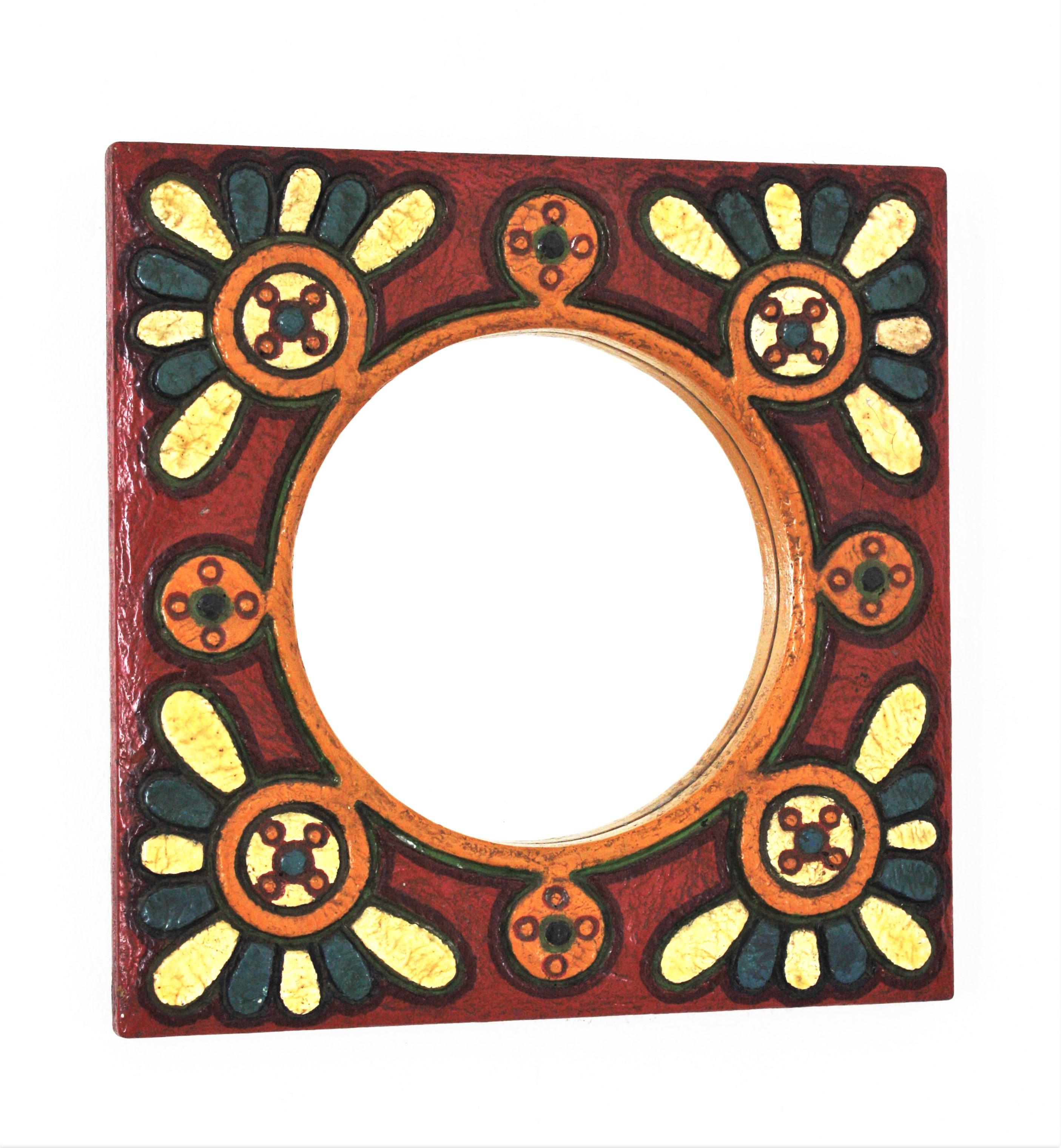 A cool hand-painted polychrome wood mirror with floral motifs . Spain, 1960s
This eyecatching wall mirror features an squared frame with flower power design surrounding the central round glass.
Colorful handpainted flowers adorning each corner on a
