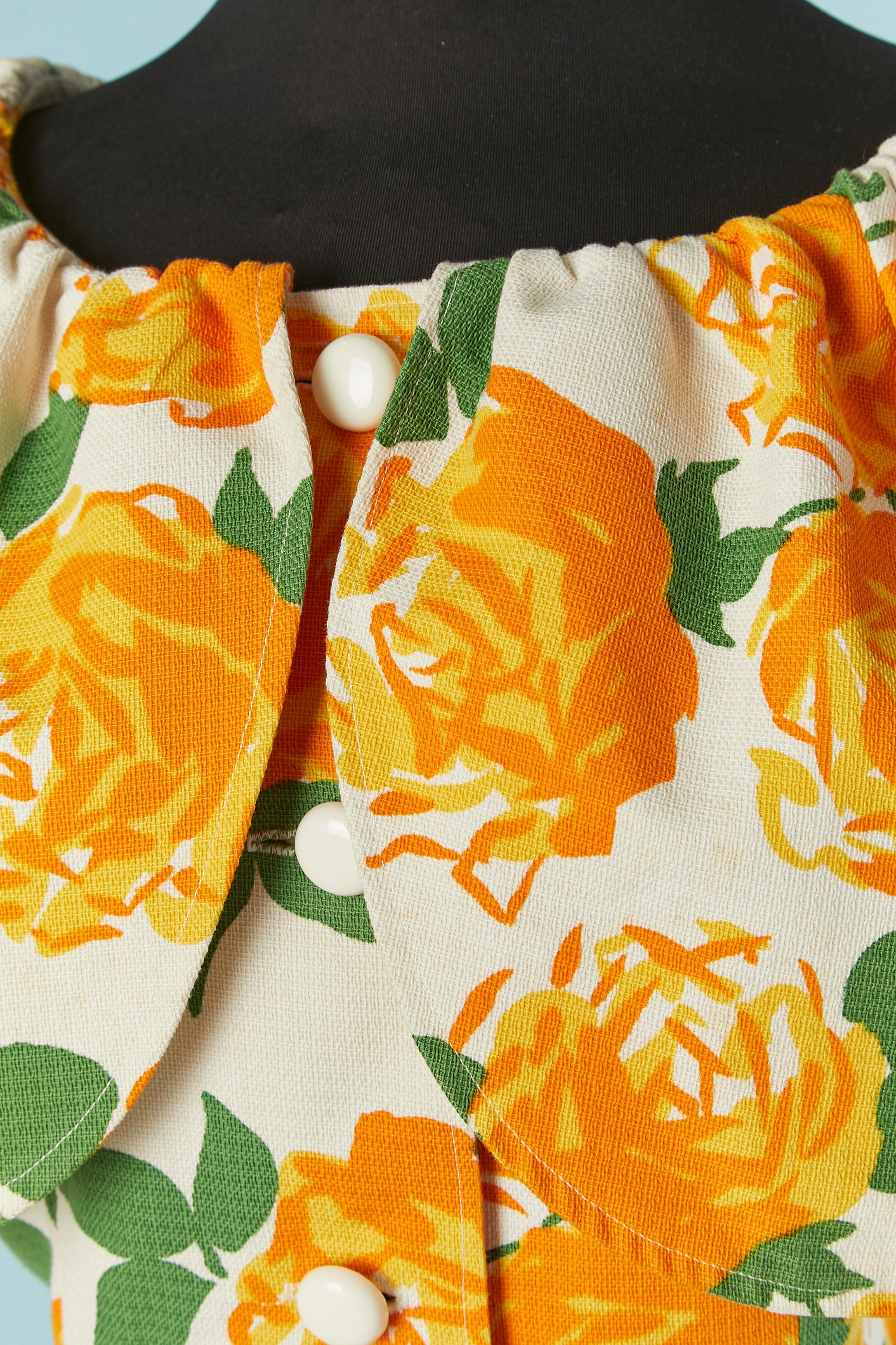Flower print dress. No fabric composition tag but the main fabric is probably cotton and lining acetate or polyester. Button and buttonhole closure + hook&eye + snap closure on the middle front. Stiff fabric ruffle under the cape on the shoulder to