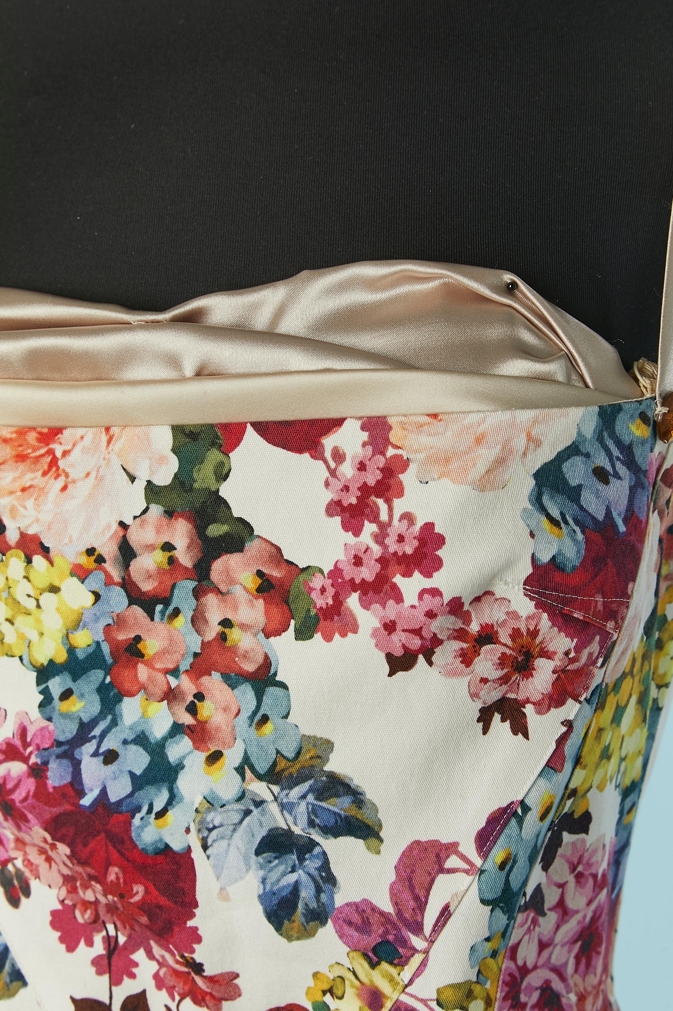 Flower printed cotton cocktail dress with visible bra. Main fabric composition: 97% cotton, 3% elastane. Lining: 92% polyester, 8% elastane. Underwired bra with adjustable shoulder-strap and zip closure on the middle back. Authenticity hologram.