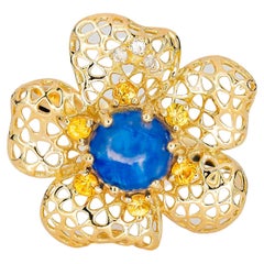 "Flower" Ring with Central Sapphire Cabochon, Yellow Sapphires, and Diamonds