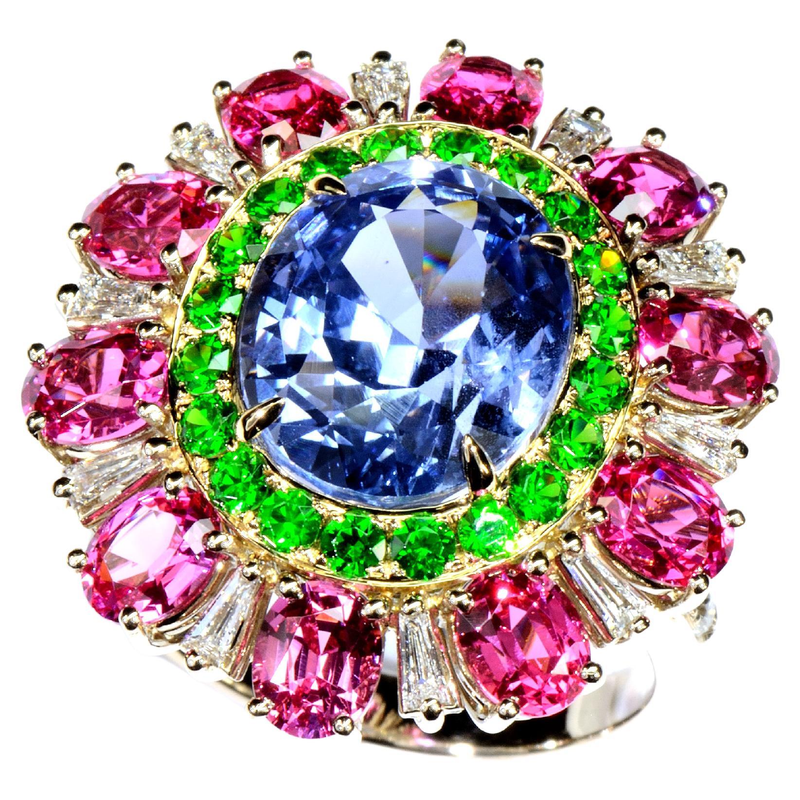 Flower ring with non heated  central Blue Sapphire from Sri Lanka, emeralds and Spinels in 18k gold 
Not Heated central Sapphire  8.27 cts
20 green garnets  0.76 cts
10 pink spinels  4.46 cts
20 round diamonds  0.64 cts
Ring weight 10.88gr
Ring size