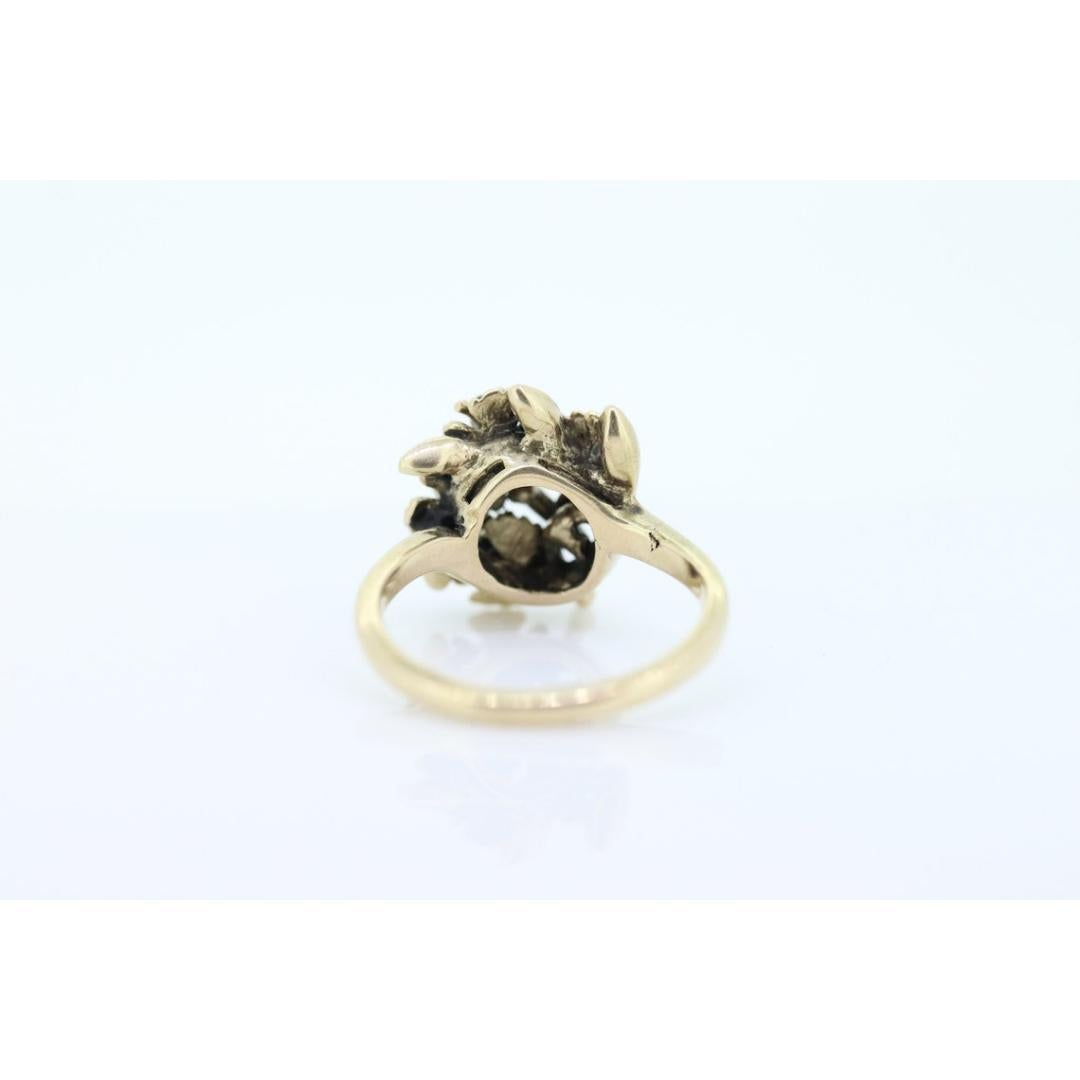 Vintage from the 1980s
Size: 6 US
Materials: Gold
Gemstone: Ruby
Gem Color: Colorless
Band Color: Gold

Style: Art Deco

Extremely rare vintage ring. A heavy 14k Ring formed into a flower with petals. Ruby is set beautifully to highlight floral