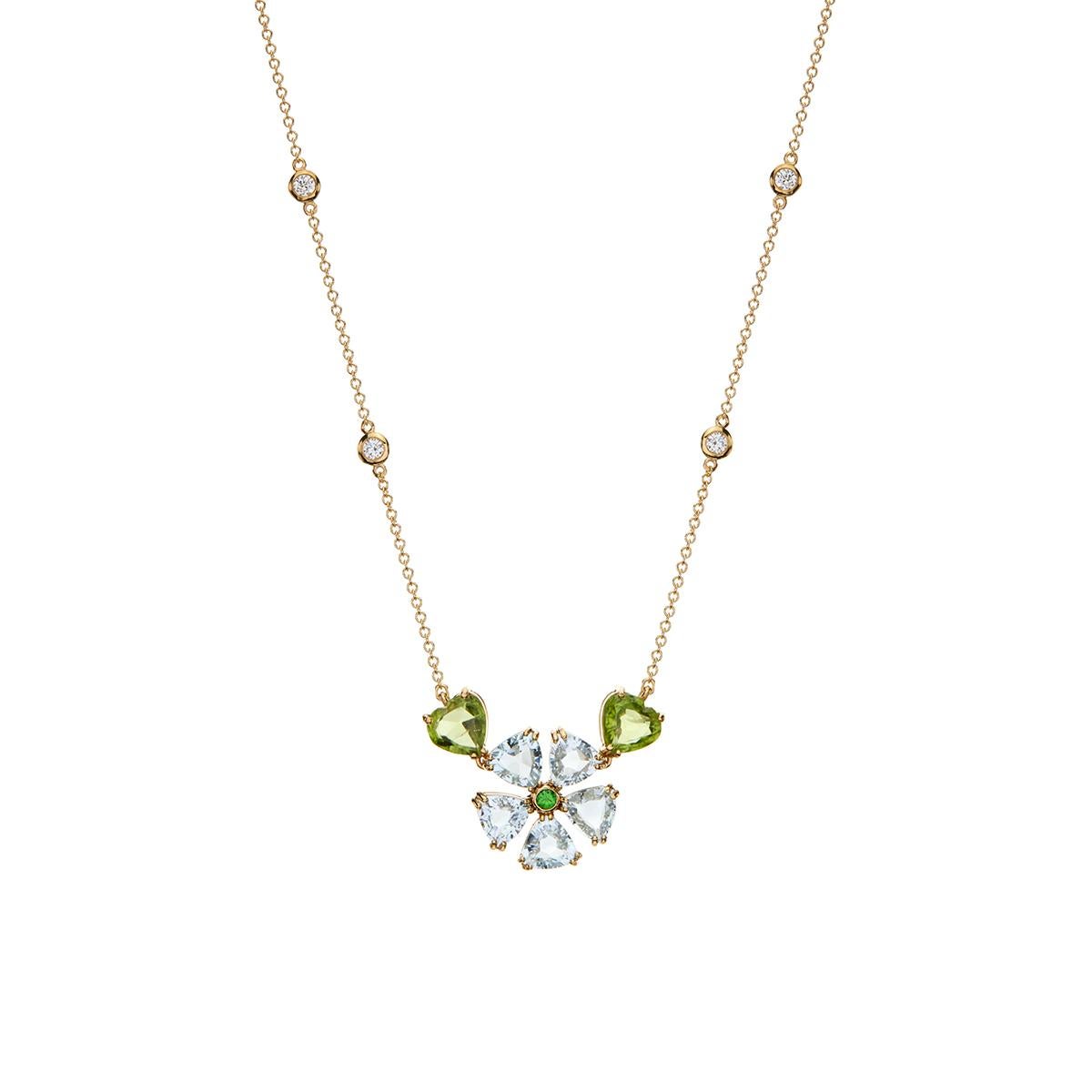 Flower Shape Pendant Necklace with Aquamarine, Peridot, Green Tsavorite garnets and Diamonds in 18Kt Yellow Gold
Unique handmade pendant necklace in flower shape with Aquamarine petals and a round green Green Tsavorite garnet as a center. A pair of