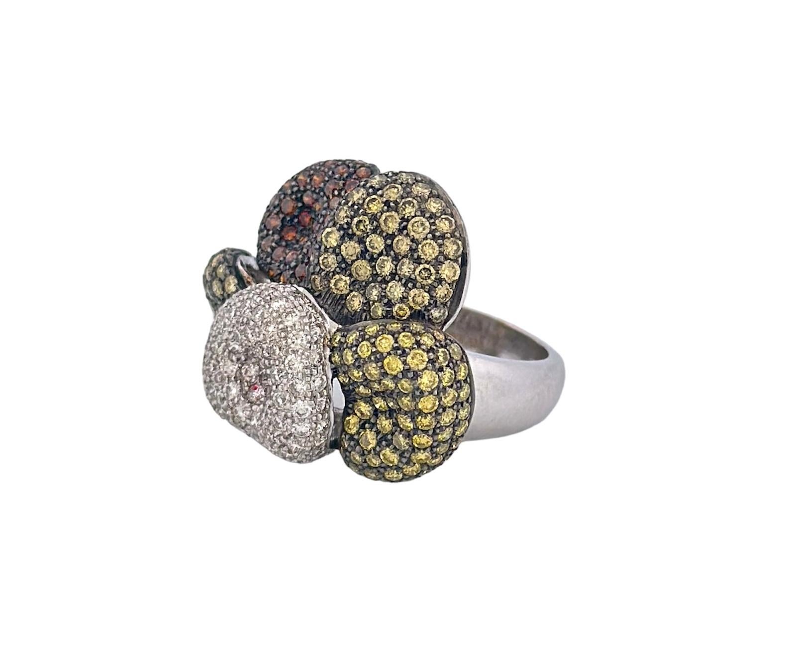 This enchanting ring, hailing from the early 20th century, is a true masterpiece of jewelry design. Crafted in the shape of a delicate and intricate flower, it features a captivating blend of yellow, white, and brown diamonds. With a total diamond