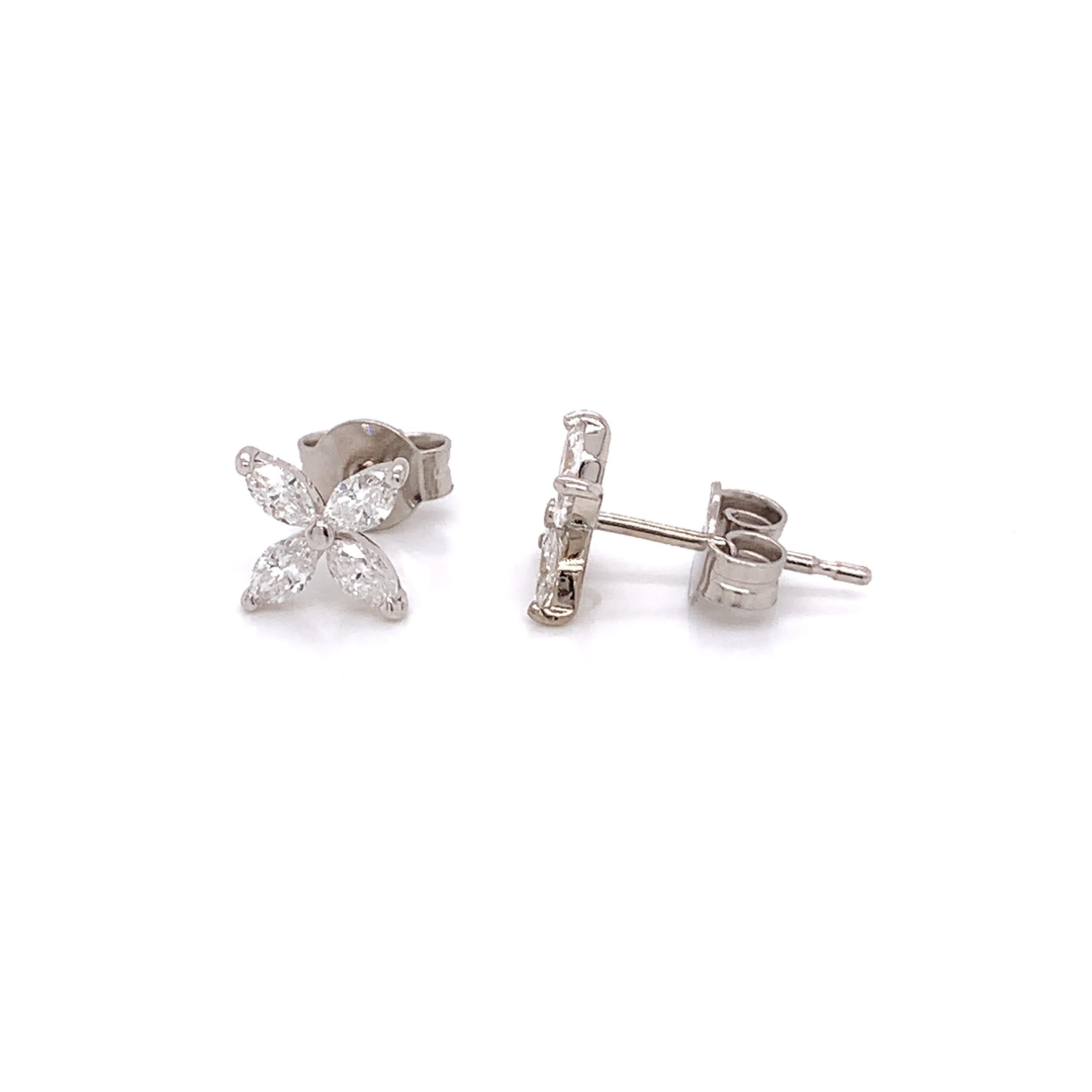 Flower shaped diamond earrings made with real/natural oval shaped diamonds. Diamond Total Weight: 0.50 carats. Diamond Quantity: 8 (oval shaped diamonds). Diamond Color: G-H. Diamond Clarity: SI. Mounted on 18kt white gold push-back setting.