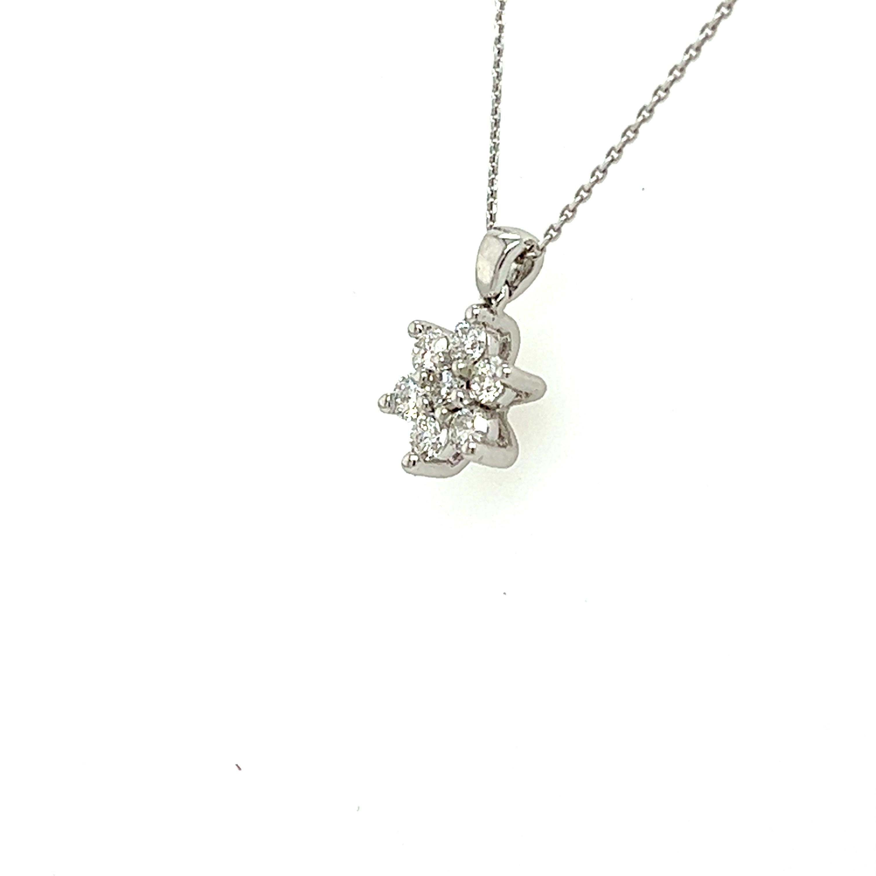 Flower Shaped Diamond necklace made with real/natural brilliant cut diamonds. Diamond Weight: 0.31 cts,  Diamond Qty: 7 (round diamonds), Color (approx): I-J,  Clarity (approx): SI1-SI2. Diameter of setting: 8.45 mm. Mounted on 18kt White Gold 2.25g