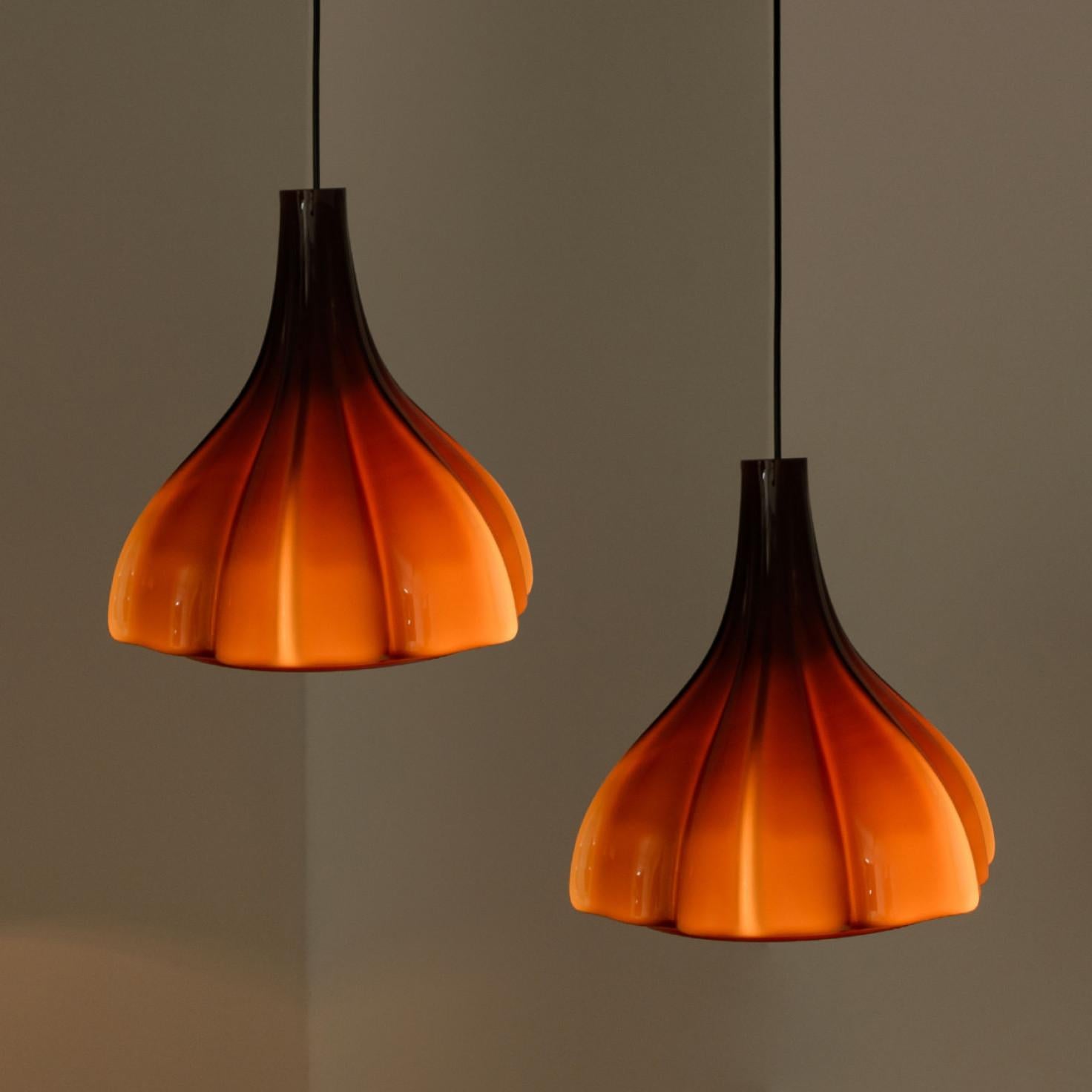 A beautiful and unique brown flower glass pendant, made in the 1970s by german designer and company Peill Putzler.
The lampshade is made of a ‘cast opaque brown glass’ with an inner white glaze, in the shape of a flower.

We have two pendant of two
