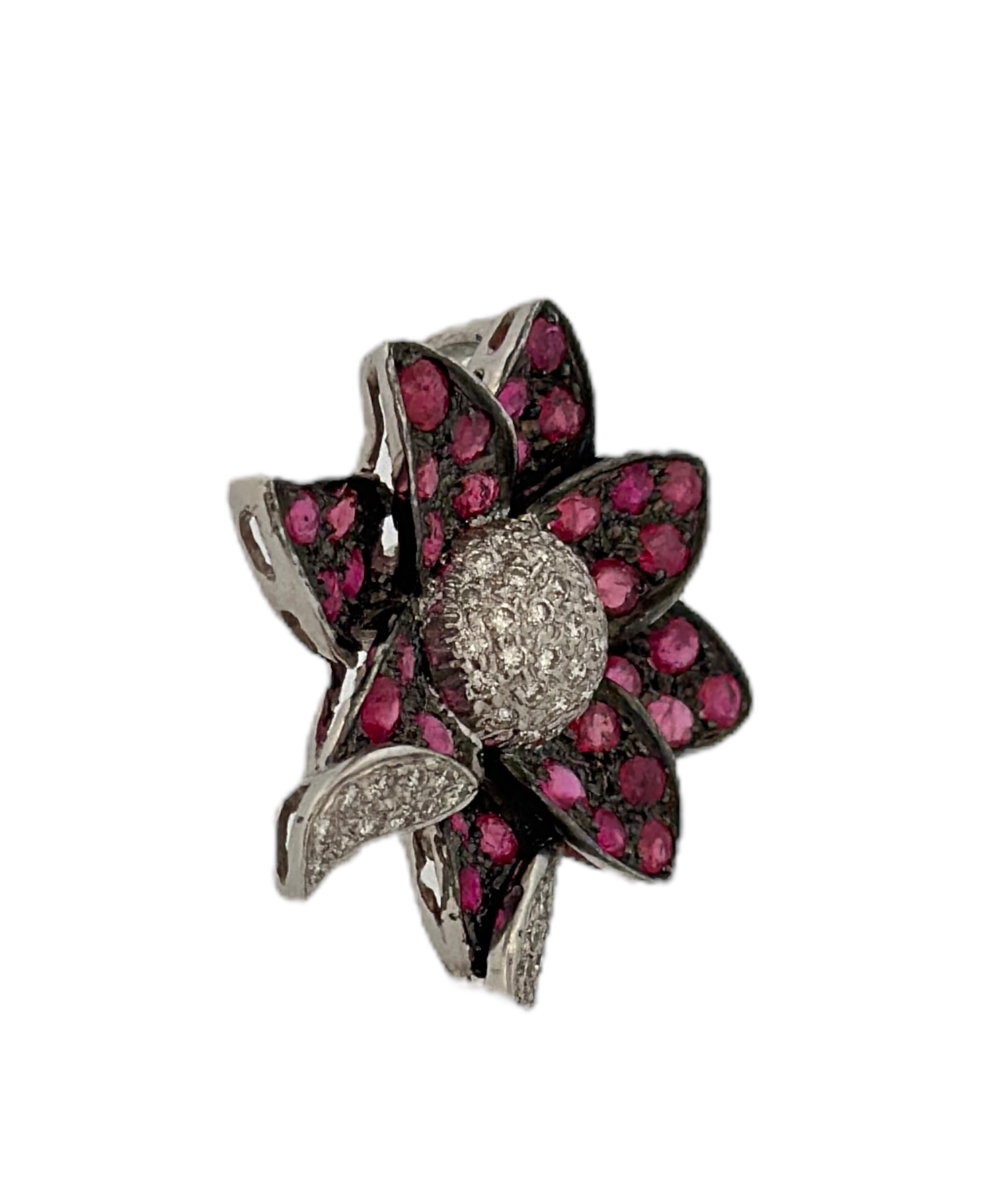 Exemplifying the timeless beauty of the early 20th century, this Flower-Shaped Pendant, adorned with White Diamonds and a Red Ruby, is truly a work of art. Weighing a total of 7.1 grams, it boasts an intricate and delicate design. The flower's