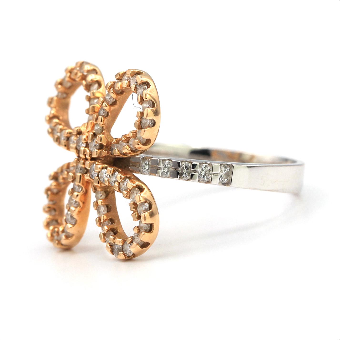 This Flower shaped ring lined with white pave diamonds weighting .41 carats. Mounted in 18k White and Rose Gold.

Stamped 