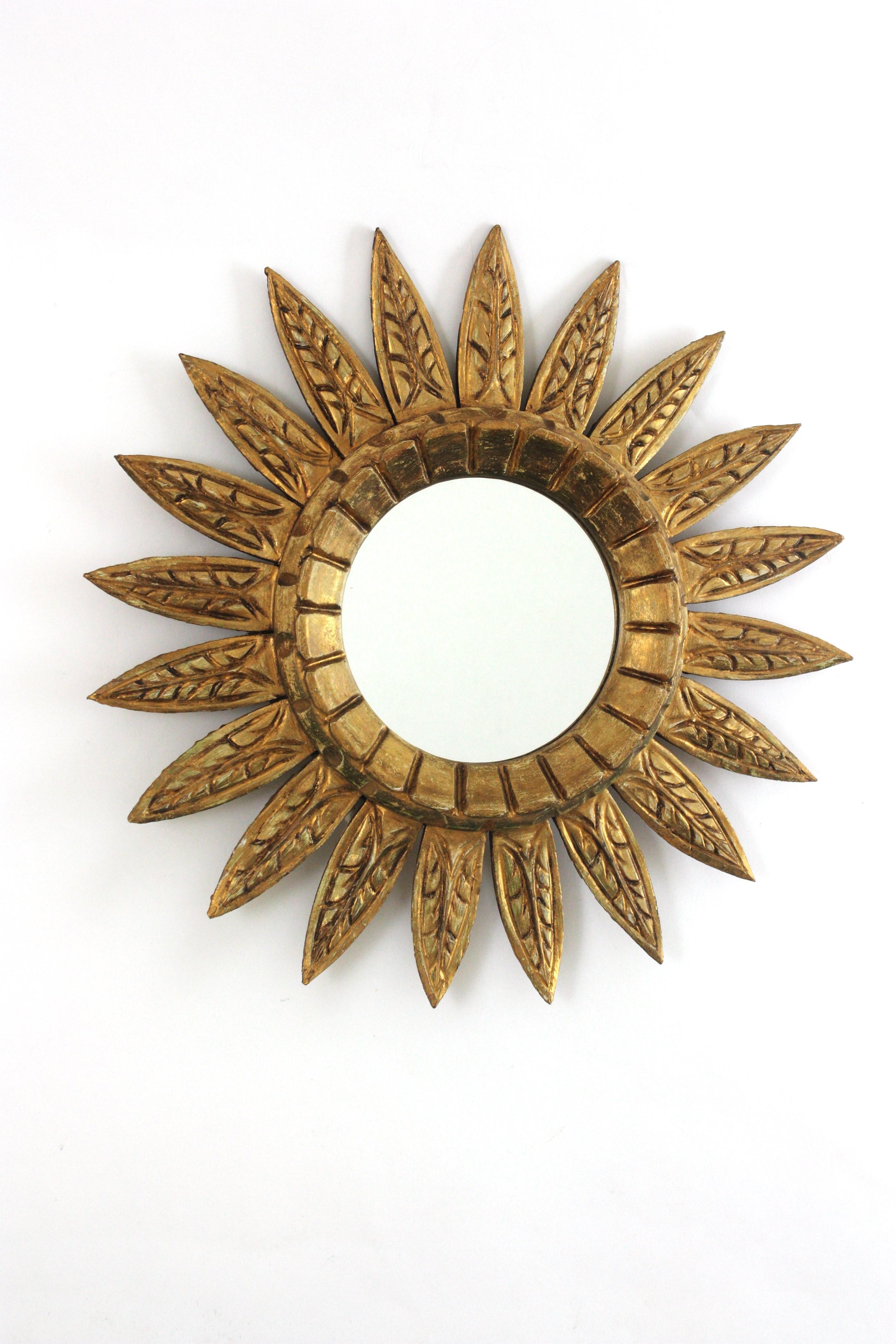 Espejo Español Sunburst con Marco de Hojas, Giltwood, Pan de Oro
_______________________________________________________________________
Espejo sunburst de madera dorada tallada de mediados de siglo, España, años 50-1960.
Llamativo espejo de sol en