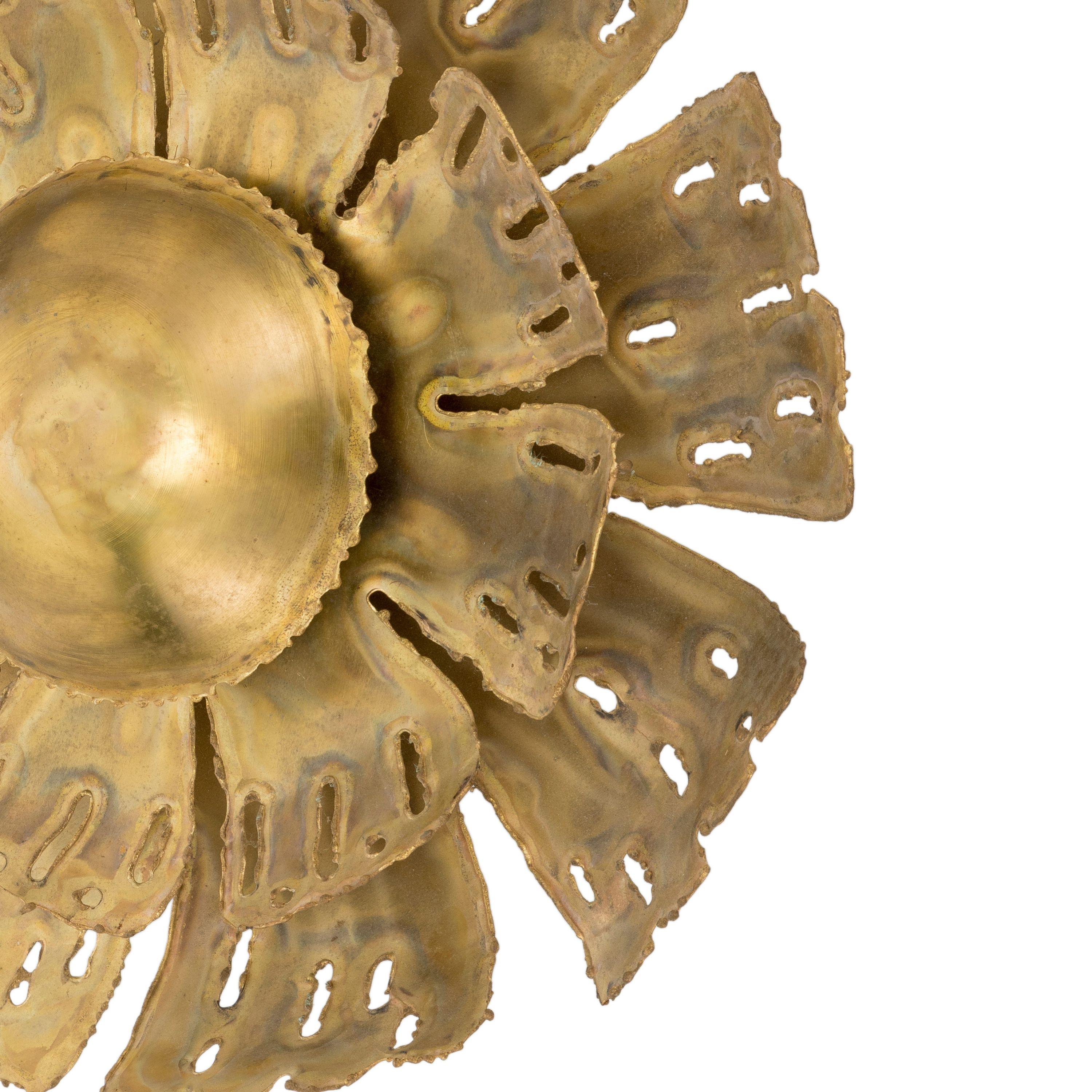 The natural brass flower-shaped wall light has a double sunburst of brass laser-cut petals and hand made decorations. 
Electrification can be customized according to the buyer's country, please specify during the ordering process.