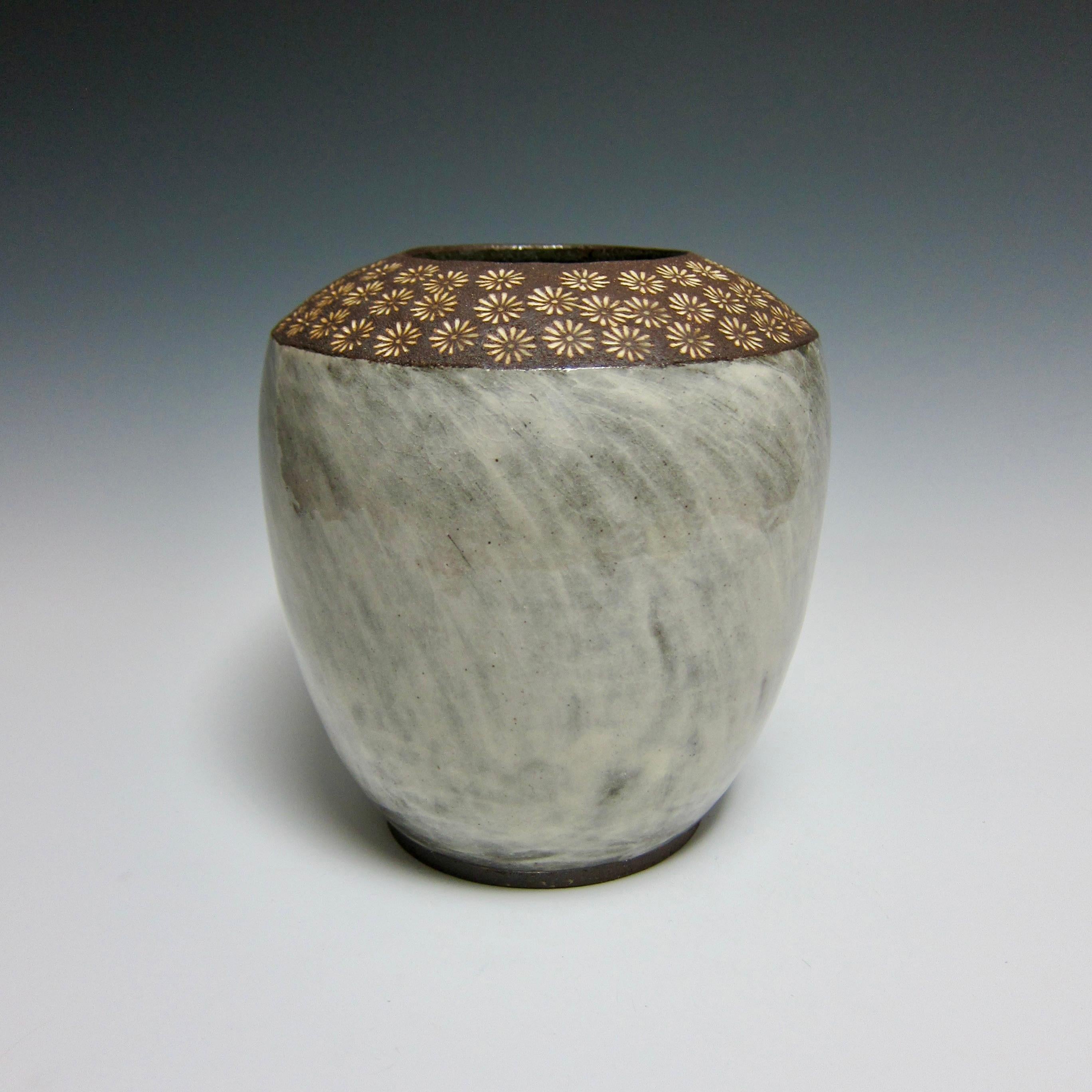Flower Stamp Buncheong Vase by Jason Fox.

A Southern Californian for over half his life, Contemporary Ceramic Artist Jason Fox draws upon his classical education in Architecture and Art History as well as his love of surfing and the ocean. He works