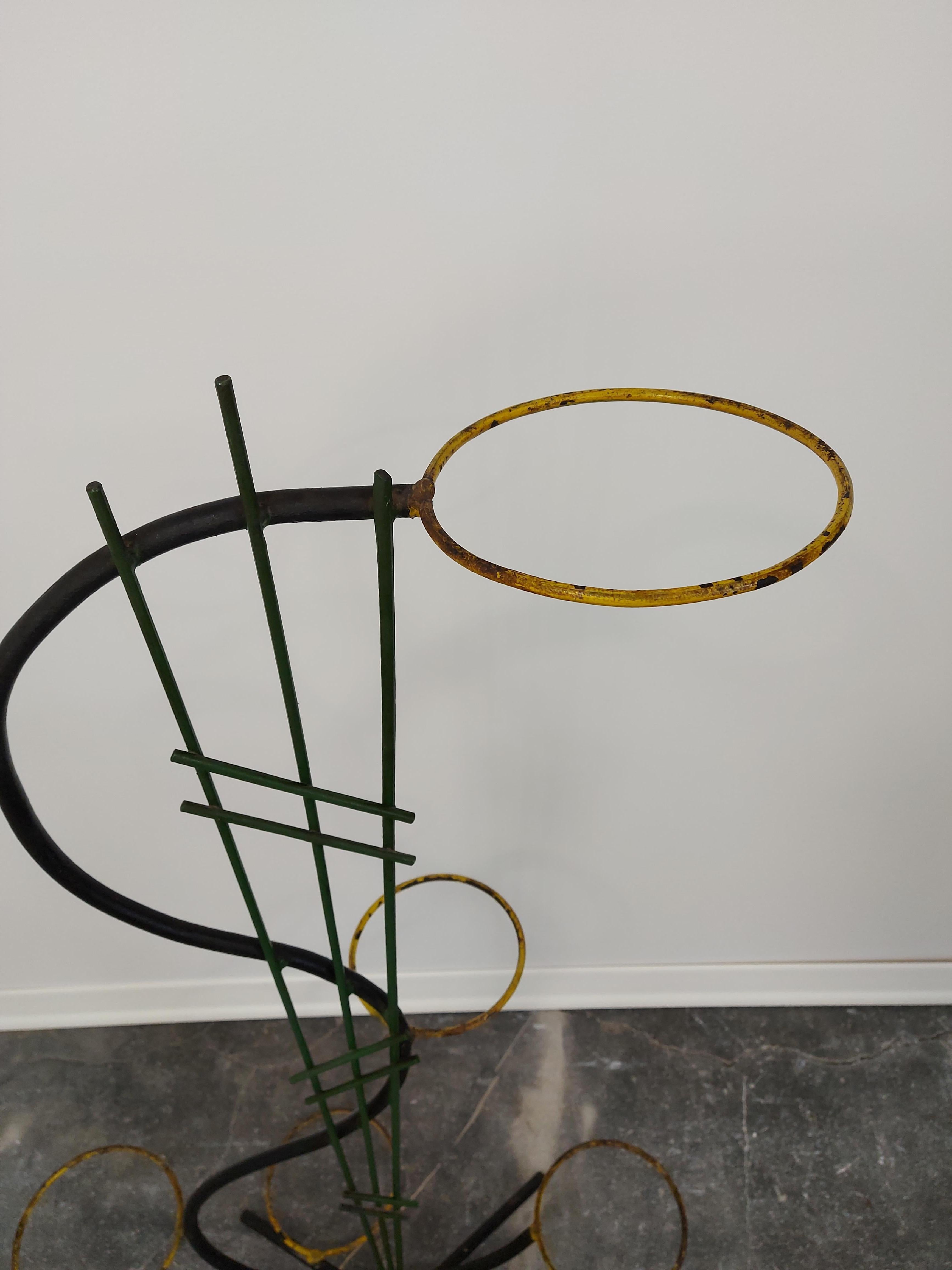 Flower stand 1950s

Material: Cast iron, metal

Colour: Black, Green, Yellow

Measures: H-114cm, W-66cm, D-44cm.