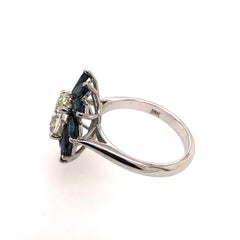 Flower Star Ring with a White Oval Diamond and Marquise Blue Sapphires