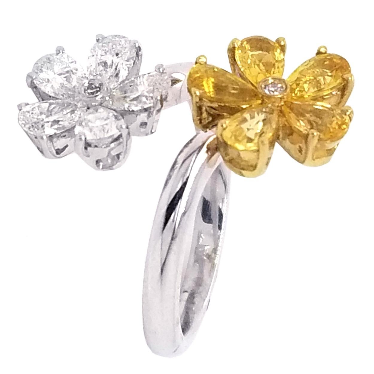 Two flower made up 5  Pear Shape diamonds and 5 Pear shaped Yellow Sapphires with a round Brilliant center for each create this beautiful fun ring made if 18K Gold.
Stones:
Diamonds: 5 Pear shaped and 2 Round Brilliant- Total weight 1.00 Ct
Yellow