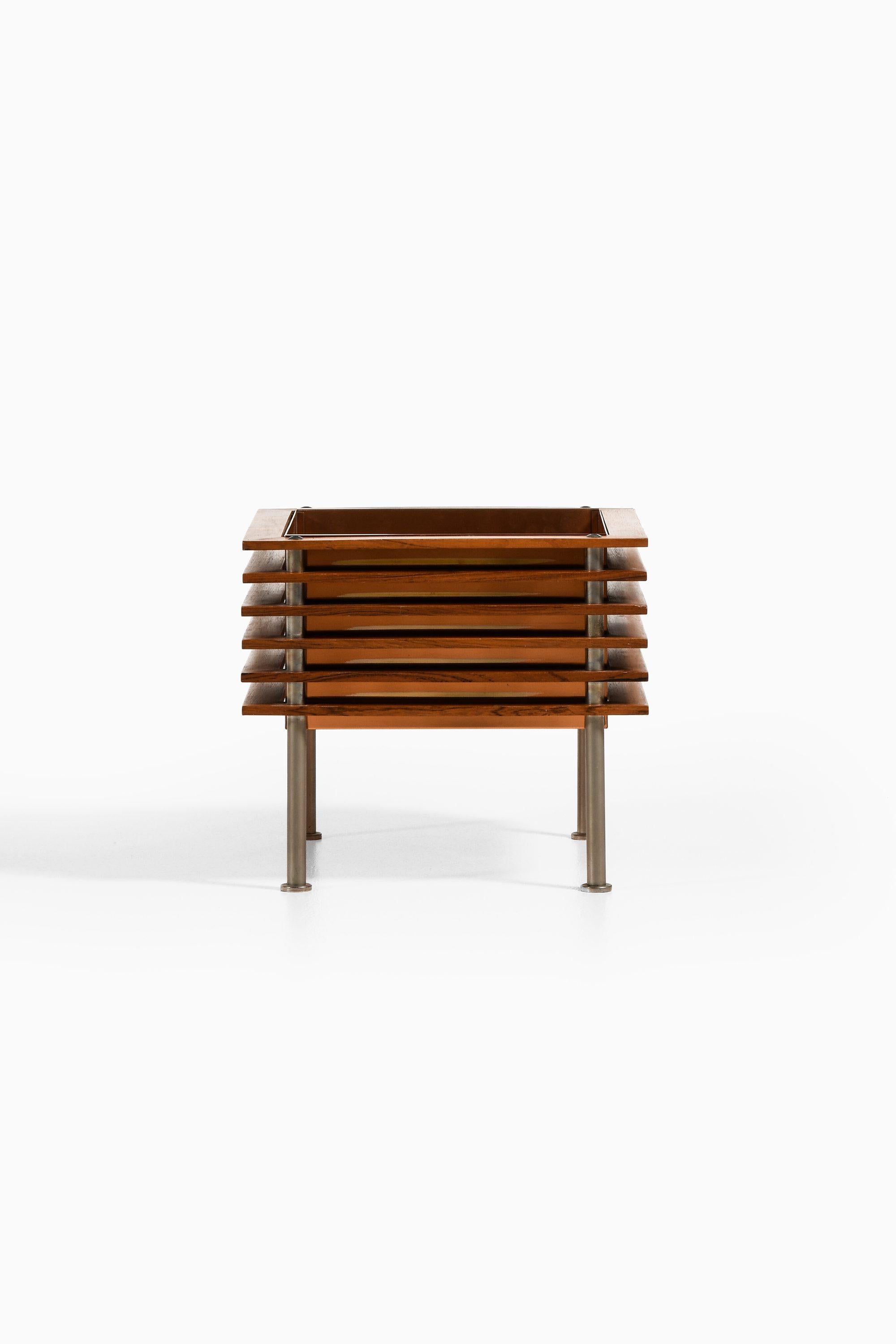 Flower Table in Rosewood, Steel and Copper Box by Nils Jonsson, 1960's

Additional Information:
Material: Rosewood, steel and copper box
Style: Mid century, Scandinavian
Produced by Troeds in Sweden
Dimensions (W x D x H): 38 x 38 x 33 cm
Condition: