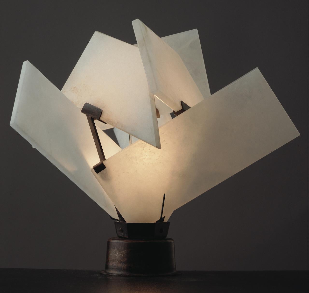 Created in 1924, this lamp derives its charm from the contemporary, complex design: the lampshade becomes a true sculpture in Pierre Chareau's hands.
