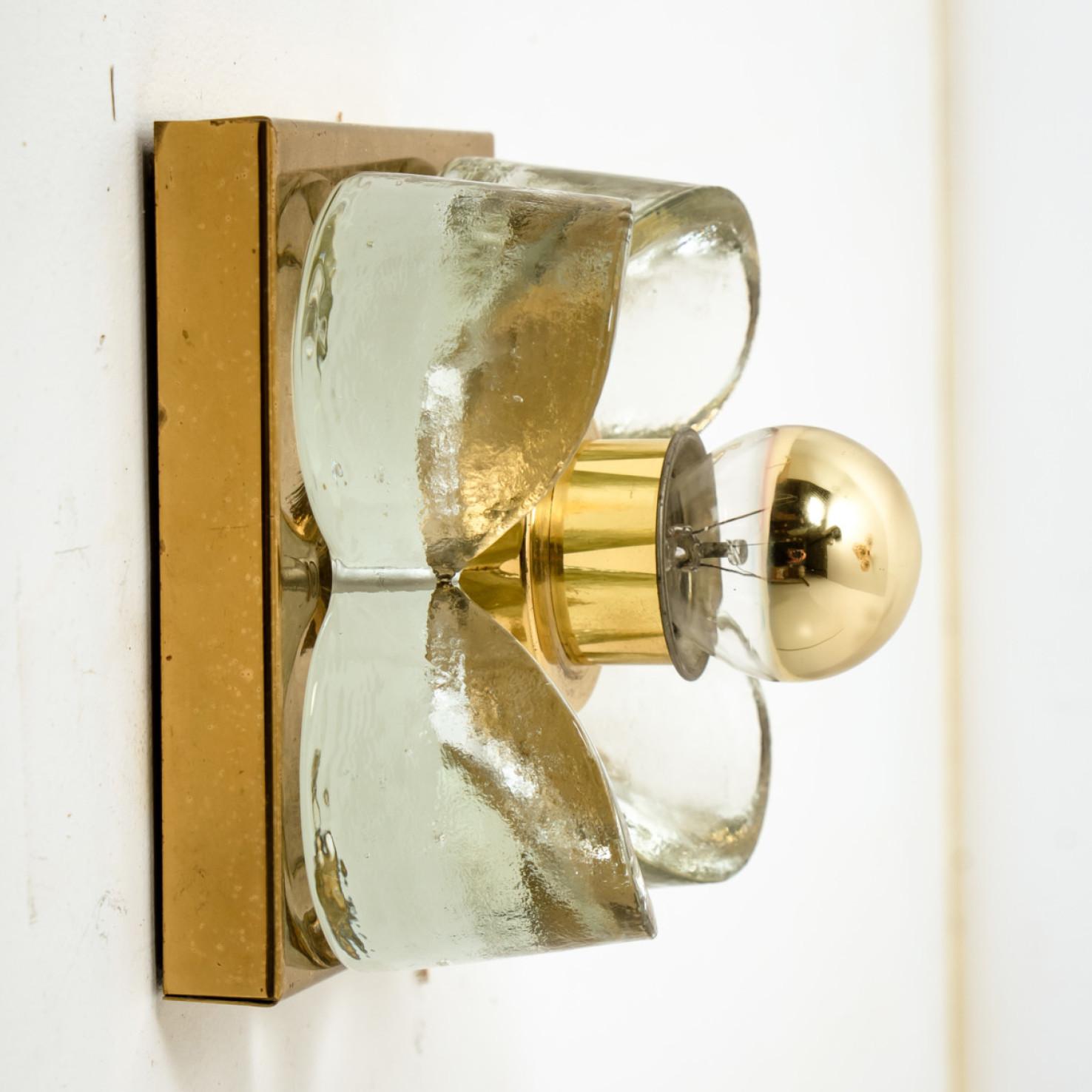 1 of the 8 flower wall lights, brass and glass by Sische Lighting, circa 1970s, Germany. Each of these wall lights is composed of a glass flowers shade screwed through round metal rings to a square brass base. High- end pieces from the 20th century.