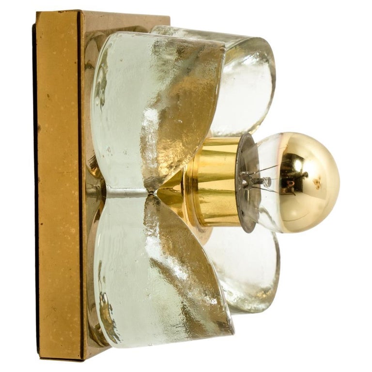 1 of the 8 flower wall lights, brass and glass by Sische Lighting, circa 1970s, Germany. Each of these wall lights is composed of a glass flowers shade screwed through round metal rings to a square brass base. High- end pieces from the 20th century.