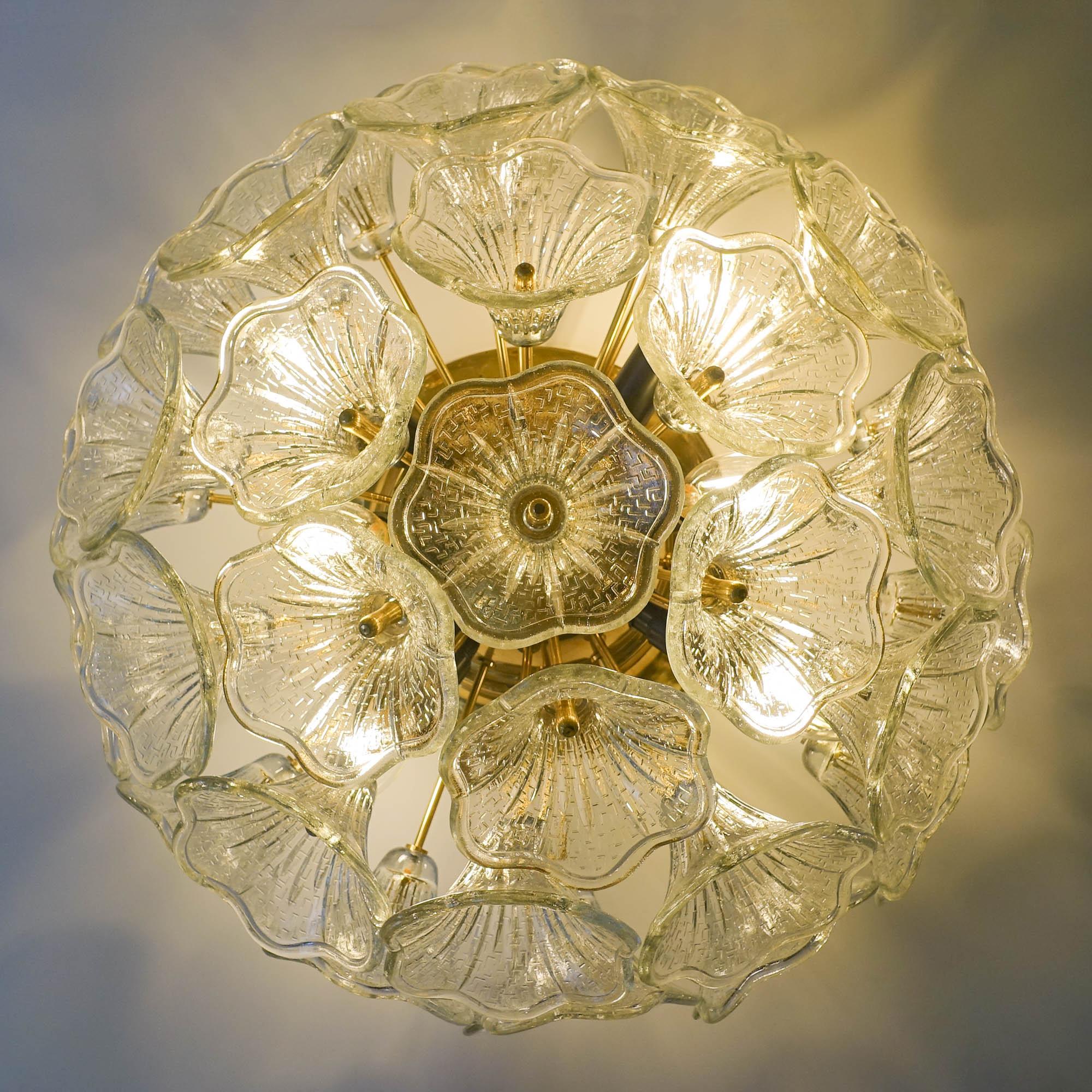 This floral design sputnik ceiling/ wall lamp was designed by Paolo Venini and manufactured by VeArt in Italy, in 1960's. It features a brass base with arms and 32 hand blown crystal flower shaped glasses. It has six E14 bulbs. When lit, the lamps