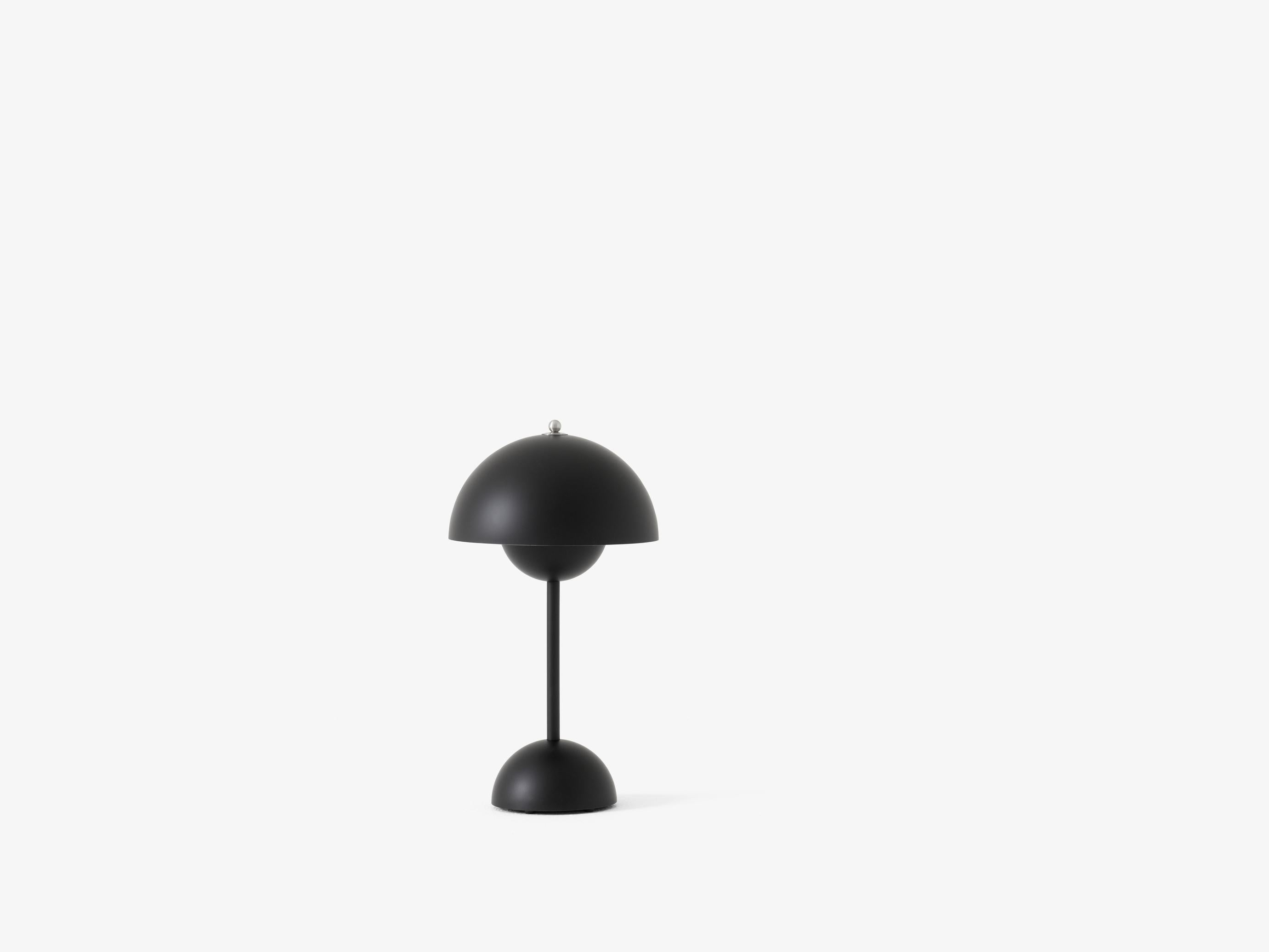 The Flowerpot, a vividly colored lamp with a rounded pendant that hangs from the semi-domed upper shade, design of Verner Panton 1968. 
Slightly smaller in size than the table lamp version, and deliberately lightweight, the portable VP9 comes