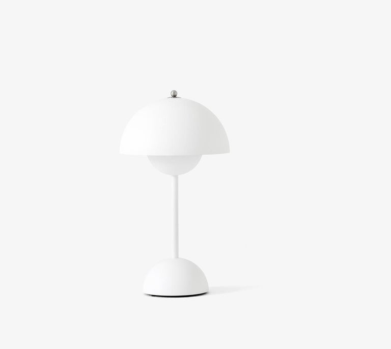 The Flowerpot table lamp with a rounded pendant that hangs from the semi-domed upper shade, design of Verner Panton 1968. 
Slightly smaller in size than the table lamp version, and deliberately lightweight, the portable VP9 comes equipped with a USB