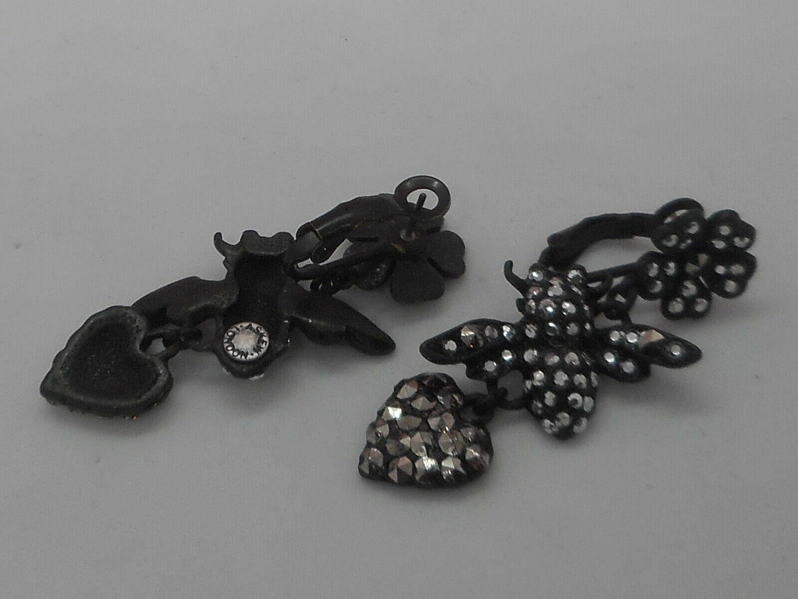 Signed Askew London Hearts Flowers and Bees  in Matt Black; set with Diamante Sparkling Crystals. Pierced clip earring fittings. Earrings measure approx. 2.00'' X 0.75''.  Signed: Askew London. An Exciting Fashion Statement! More Beautiful in Real