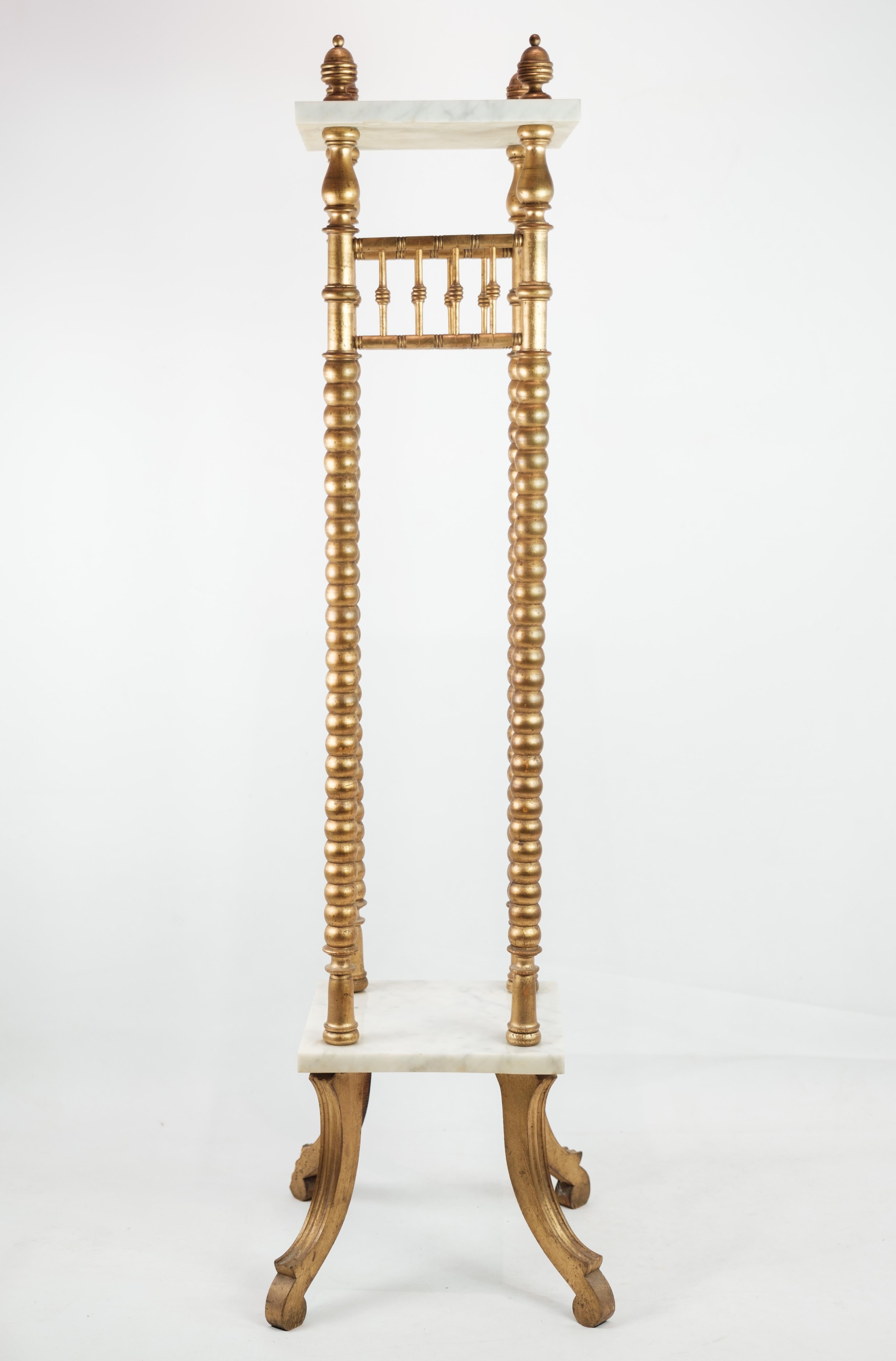 This elegant flowers stand from the 1930s exudes opulence and sophistication with its gilded columns and luxurious marble slabs. Crafted with exquisite attention to detail, it adds a touch of timeless beauty to any space.

The gilded columns lend an