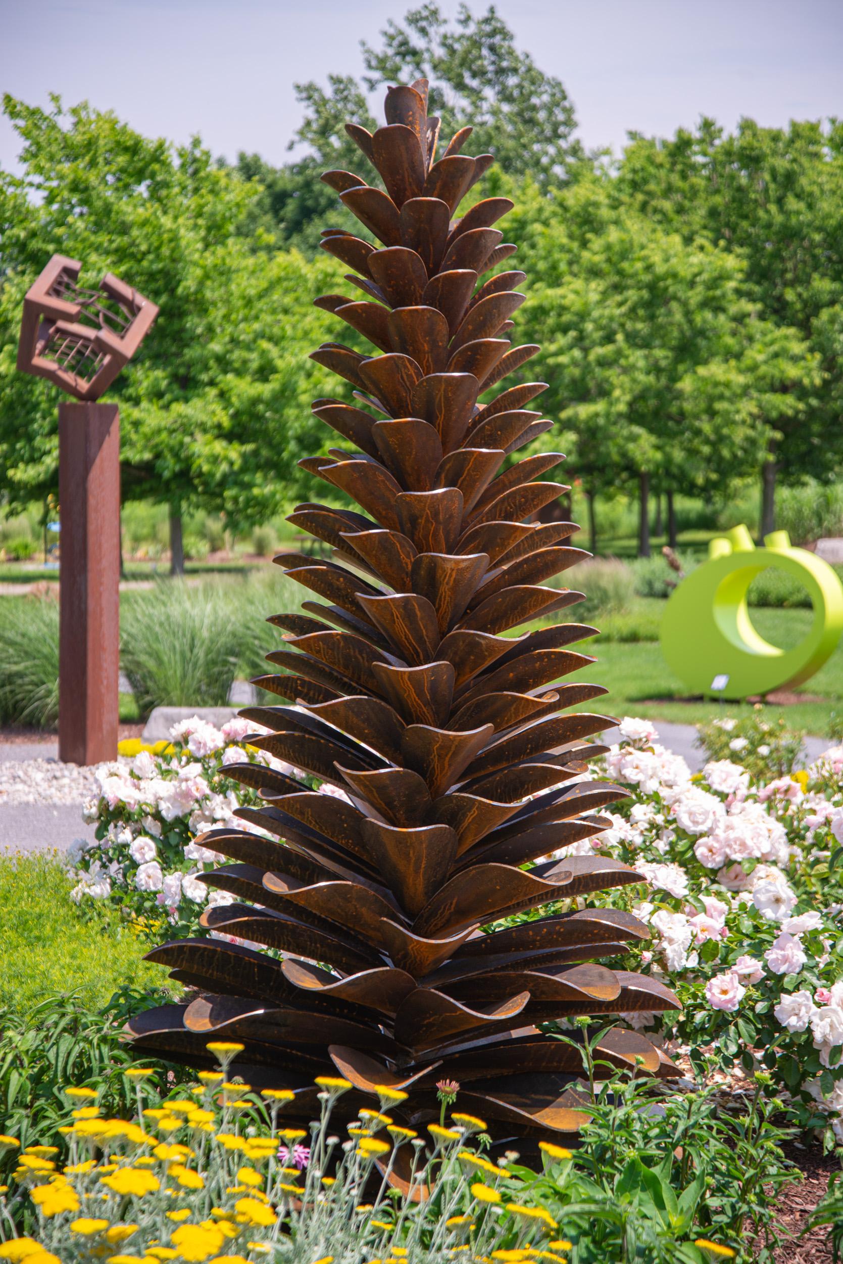 This large, rusted, contemporary, Corten steel, outdoor sculpture was created by artist Floyd Elzinga.

Canadian sculptor Floyd Elzinga’s pine cones have become one of his signature images and now grace many outdoor venues in Canada. Three large