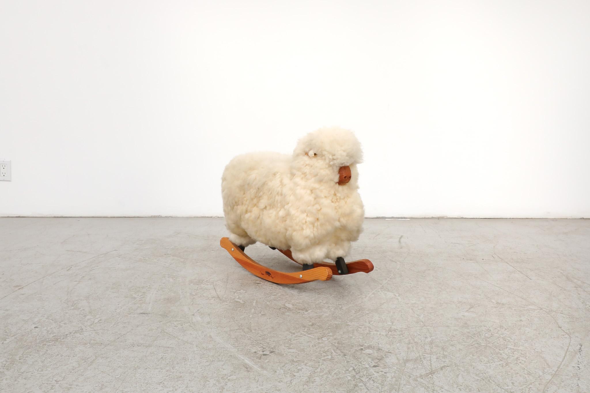 Beautiful, late 1960's, Mid-Century rocking sheep manufactured by Britain's Roger Newman. Made with real Welsh sheepskins, hand cured and washed in Gwernogle, Wales. Condition with visible wear, is consistent with its age and use.