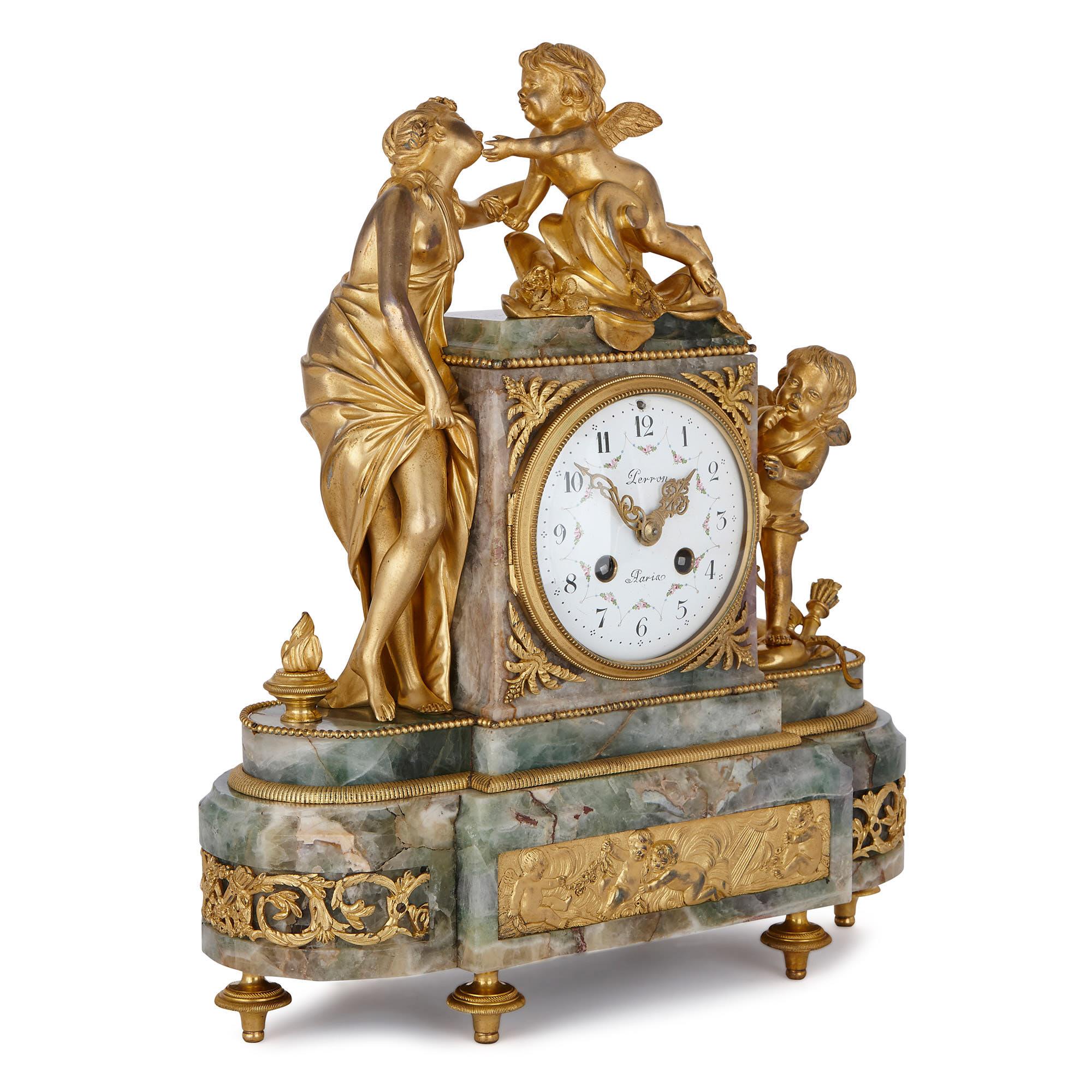 Created France at the turn of the century, this mantel clock has been crafted from the rare green / purple gemstone, fluorite, and is mounted with gilt bronze sculptures of Venus, the Goddess of Love, and two winged cherubim. 

The fluorite clock