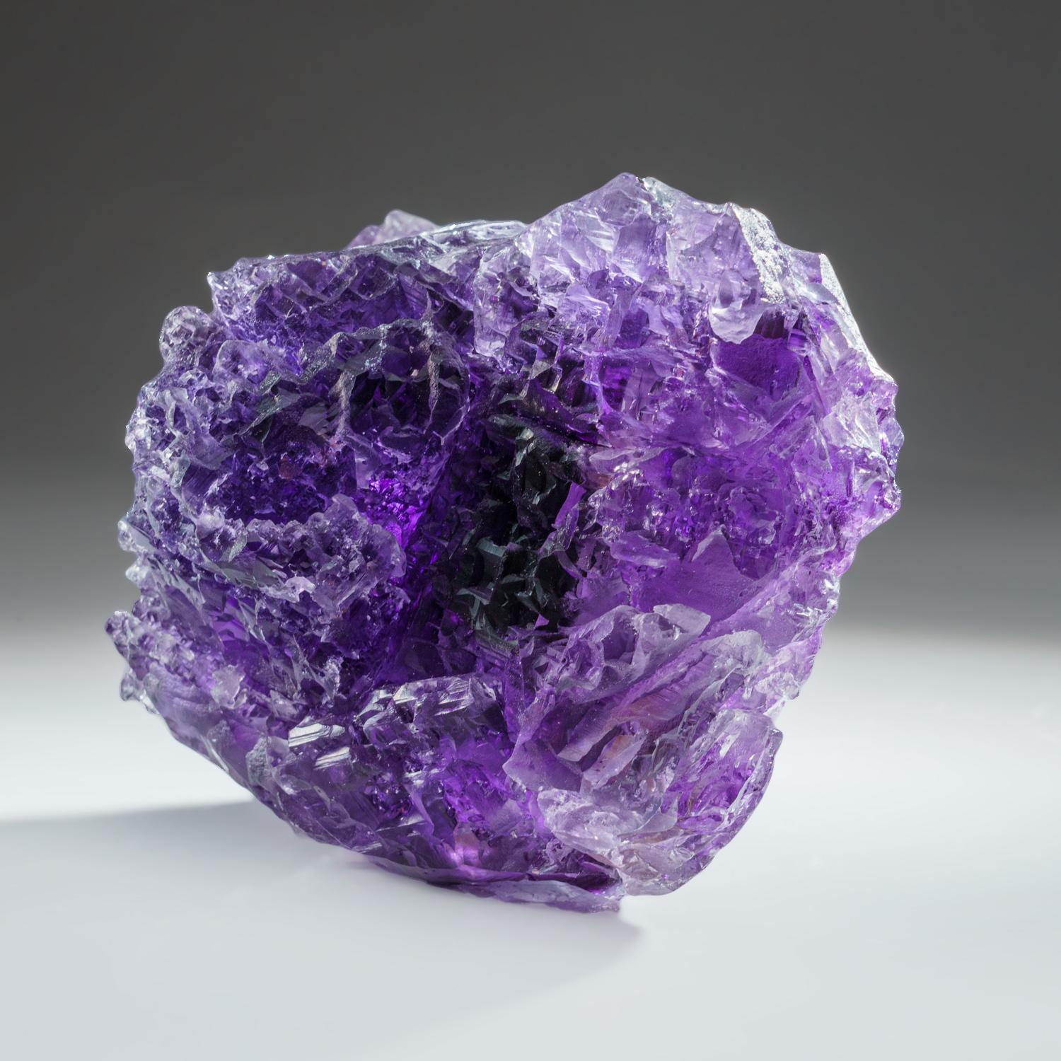 Large double-sided cluster of translucent fluorite crystals. The fluorite is gray color in the core with a thin purple outer layer that is most noticeable in the crystal corners. The cubic crystals have many smaller cubic crystal faces on the