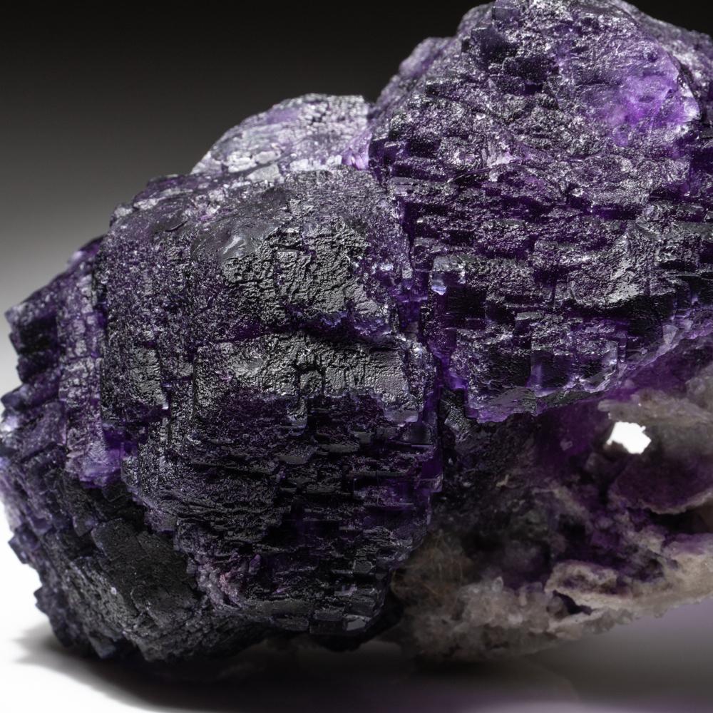 Transparent purple fluorite crystals with minor hemimorphite crystal matrix. The crystal is externally unblemished, and only one internal flaw, otherwise exceptionally clean. Fluorite is considered a healing crystal for its ability to reduce stress