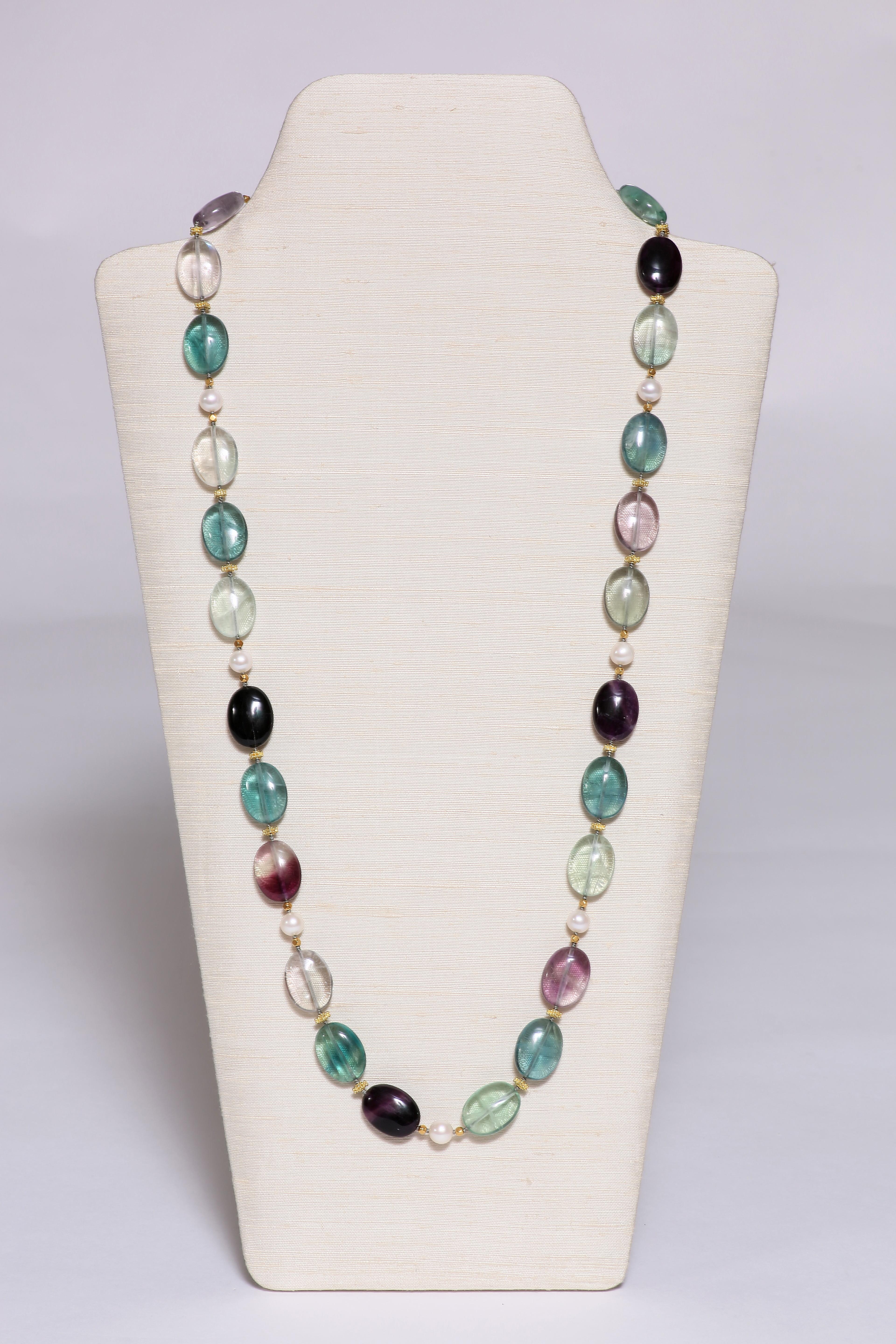 Perfect for summer. The oval-shaped fluorite beads of crystal clear color, light green, lilac and purple, spaced by freshwater pearls and 18k faceted gold beads.