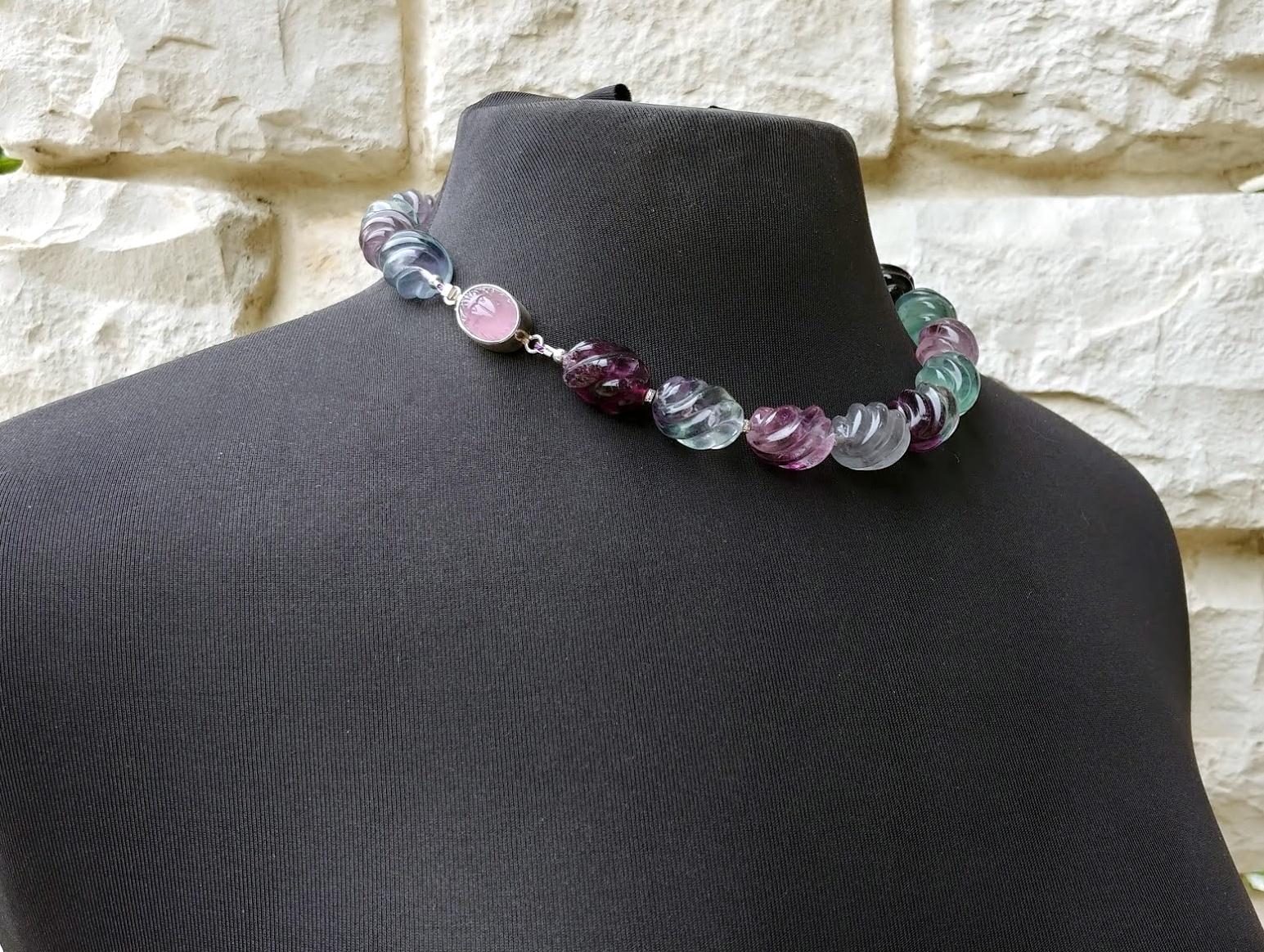 The length of the necklace is 18.5 inches (47 cm). The size of the fluted twist beads is 15 x 20 mm.
The fluted twist fluorite beads in this necklace range from crystal clear to jewel-tone purple and green.
This unusual mineral presents drastically