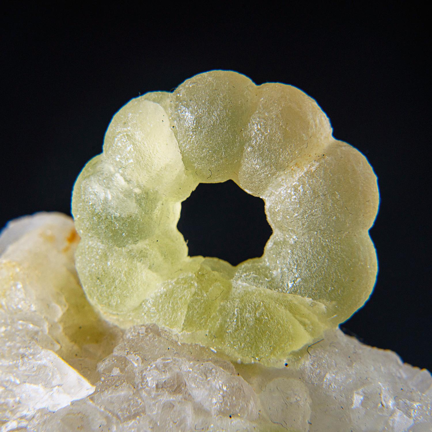 From De'an Mine, Wushan, Jiangxi Province, China

Lustrous botryoidal </span>green fluorite crystals on white quartz crystals. The quartz crystals are octahedral form with satin luster on the crystal faces caused by microscopic crystallization