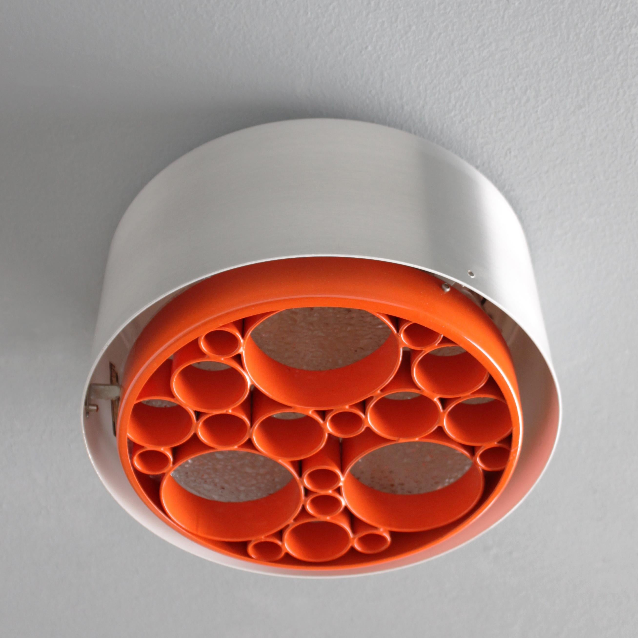 Flush mount 'Alliance' by Raak Amsterdam Holland. This is an early production with the orange rings in metal. Model P-1462.23. One bulb E27/E26 of max 60 watt, the electricity is used but in a good condition, approved to European