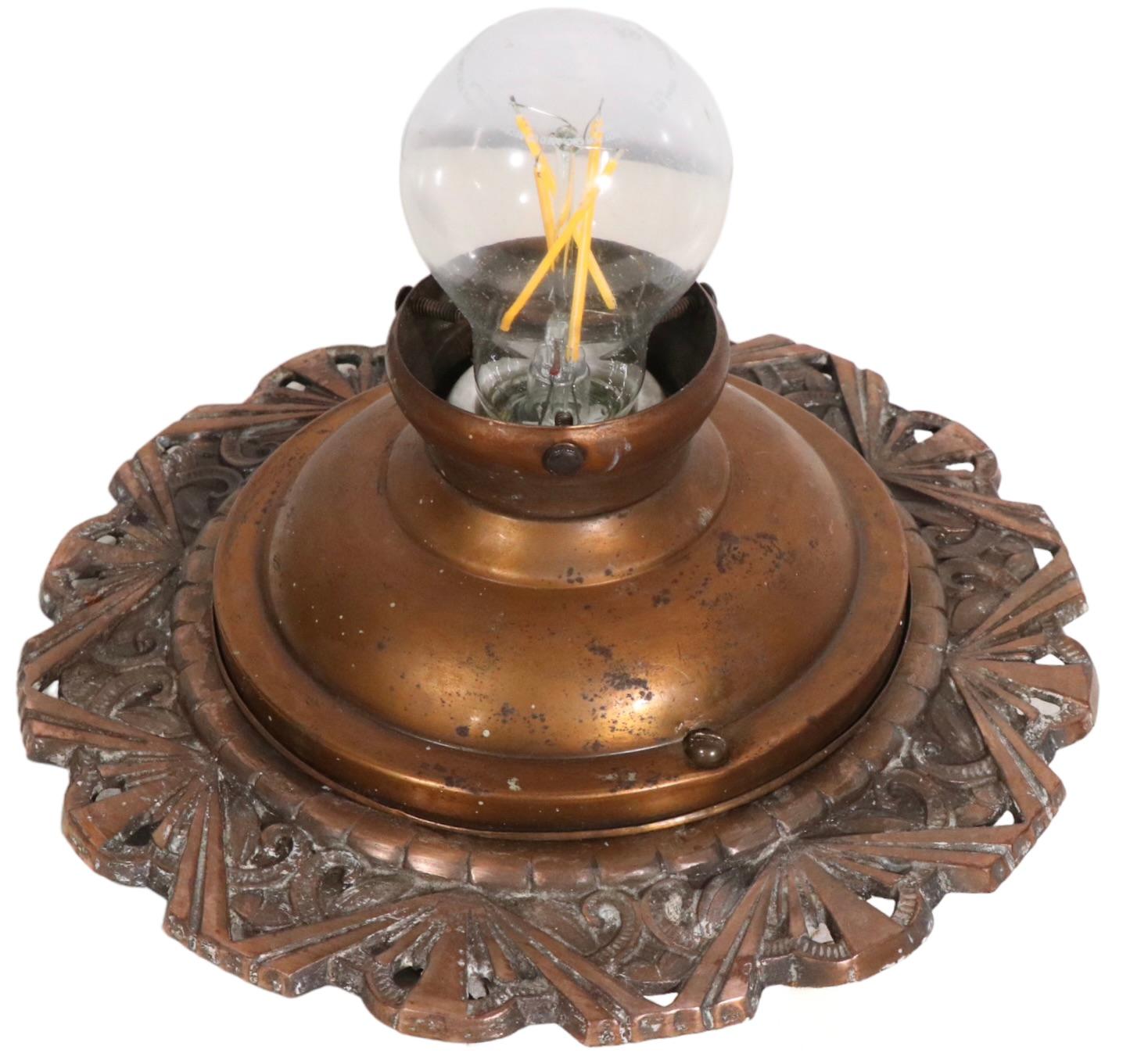 Art Deco flush mount fixture with decorative cast bronze ceiling mount and  period ruffled edge halothane shade. The fixture is in very good, clean, original and working condition, ready to install. Minor ceiling paint evident on the bronze