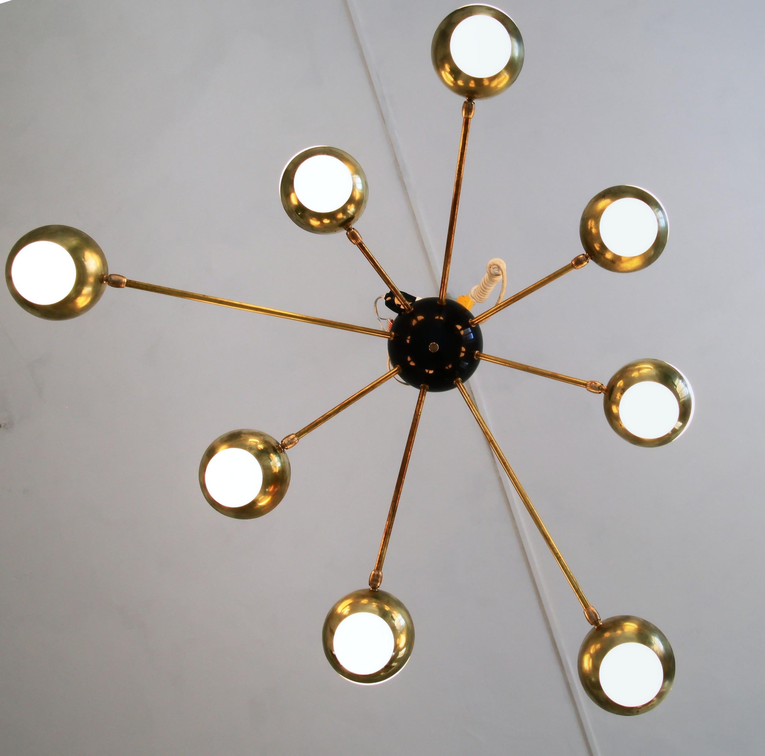 This chandelier is specifically designed for low ceilings, with a height of only 13 inches (32 cm). The arms and shade holders are made of brass, while the central part is made of metal to hold the leverage. The glass spheres have a diameter of