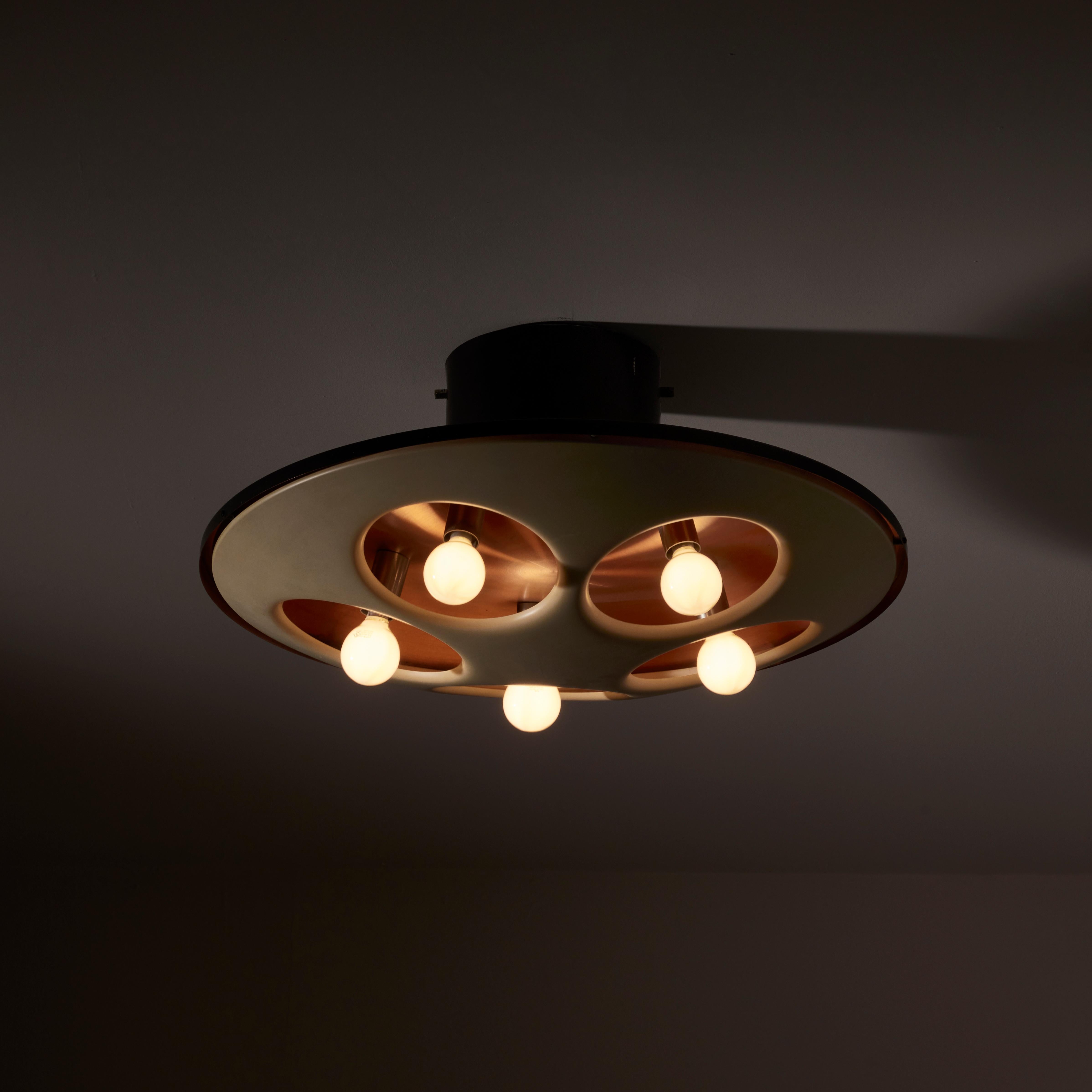 Flushmount ceiling light by Stilnovo. Manufactured in Italy, circa 1950s. Lacquered metal with cut outs encircling the exterior shade. Each hole has a bulb poked through for a nice retro look. Copper interior finish is shown through. Rewired for