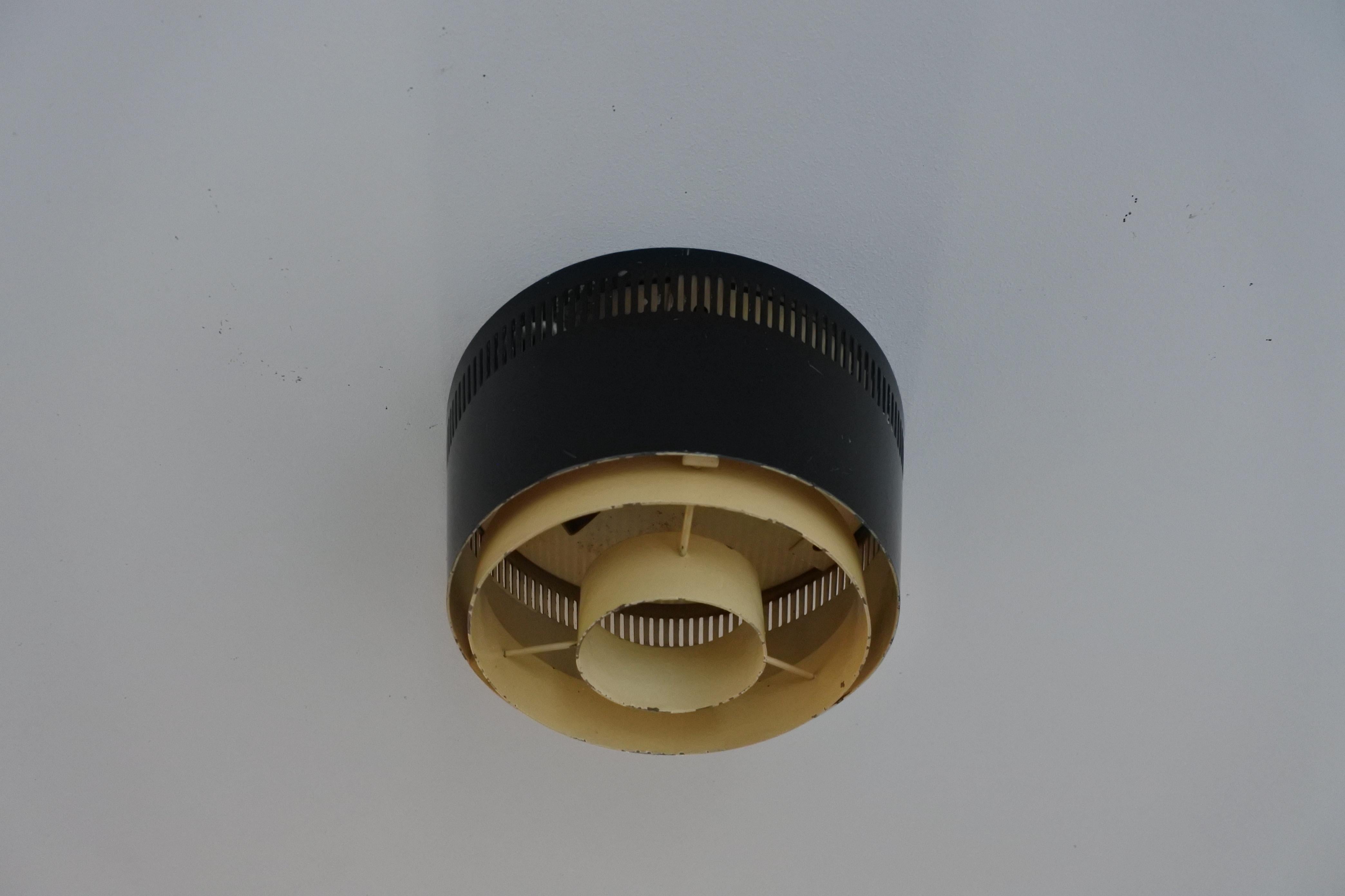 One flush mount ceiling light. 
Designed and manufactured in Finland in the 1950s. 
Black and white lacquered metal. 
Each light takes one E27 bulb.
Each marked Itsu

Outstanding ceiling lamp. 2 available.

Original electrical system. To be safe,