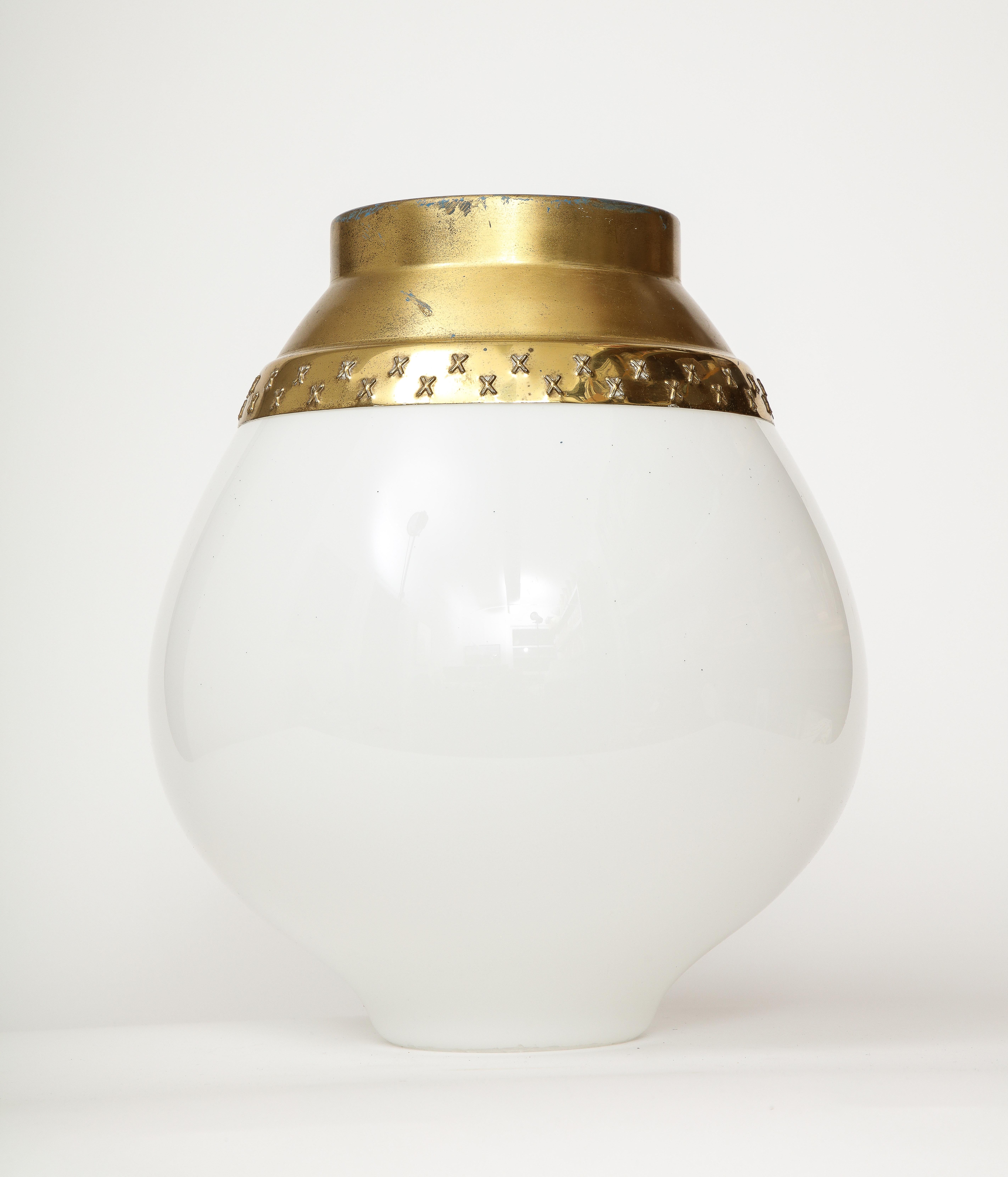 This elegant ceiling light by Lisa Johansson-Pape is gracefully minimal, with sloping art-deco lines and a brass shade that's quintessentially Finnish. This ceiling light is reminiscent of the work of other preeminent Finnish lighting designers such