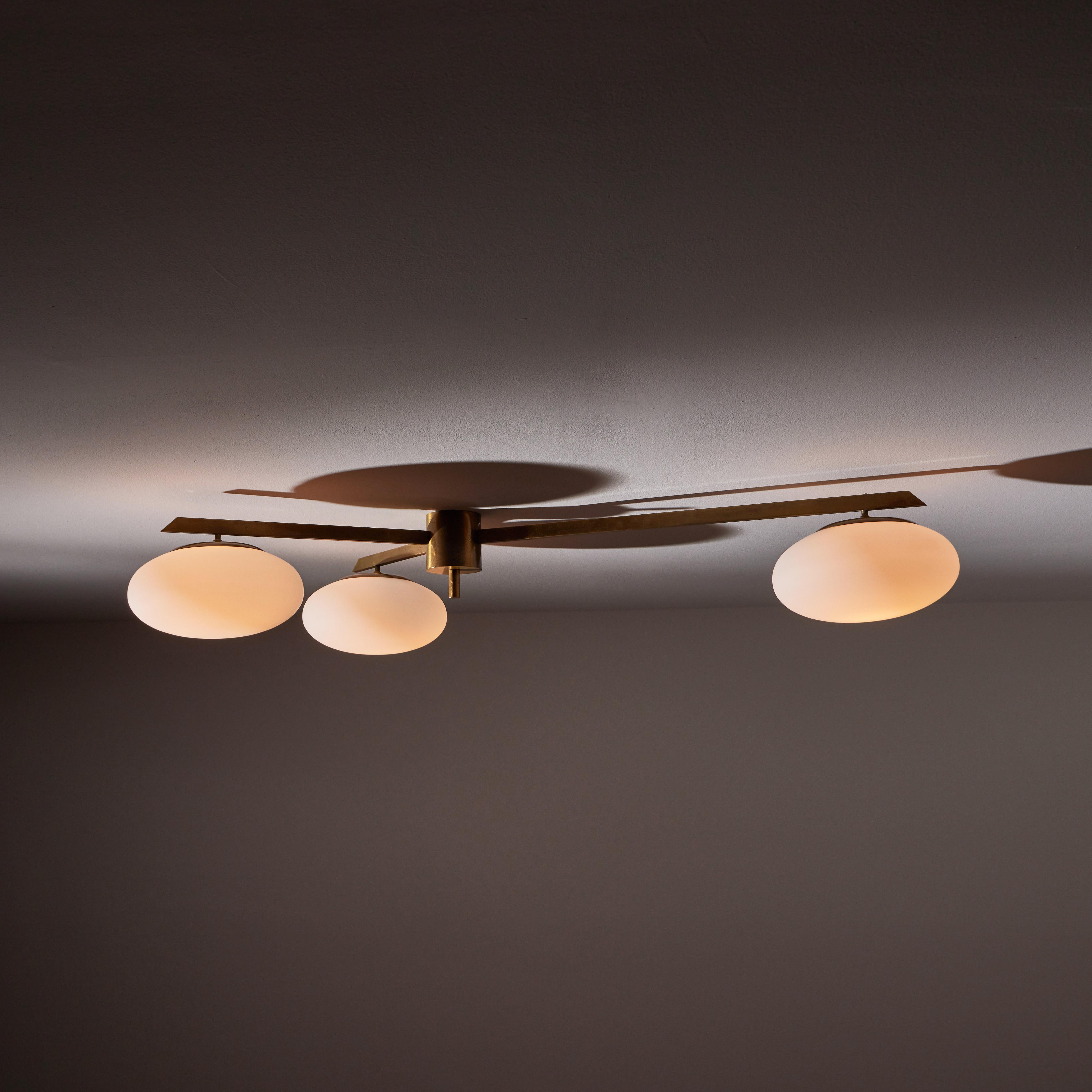 Flush mount ceiling light by Arredoluce. Manufactured in Italy, circa 1950s. Brass, brushed satin glass diffusers. Rewired for U.S. standards. Original canopy. We recommend three E27 40w maximum bulbs. Bulbs provided as a one time courtesy.